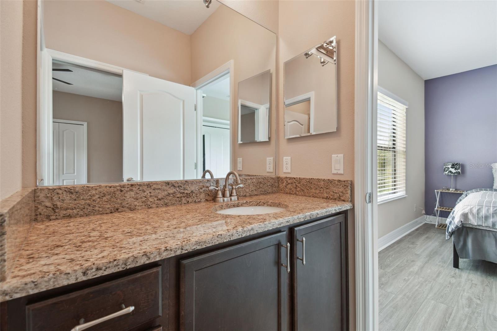 There is ample counter and cabinet space in this Jack-n-Jill bathroom.