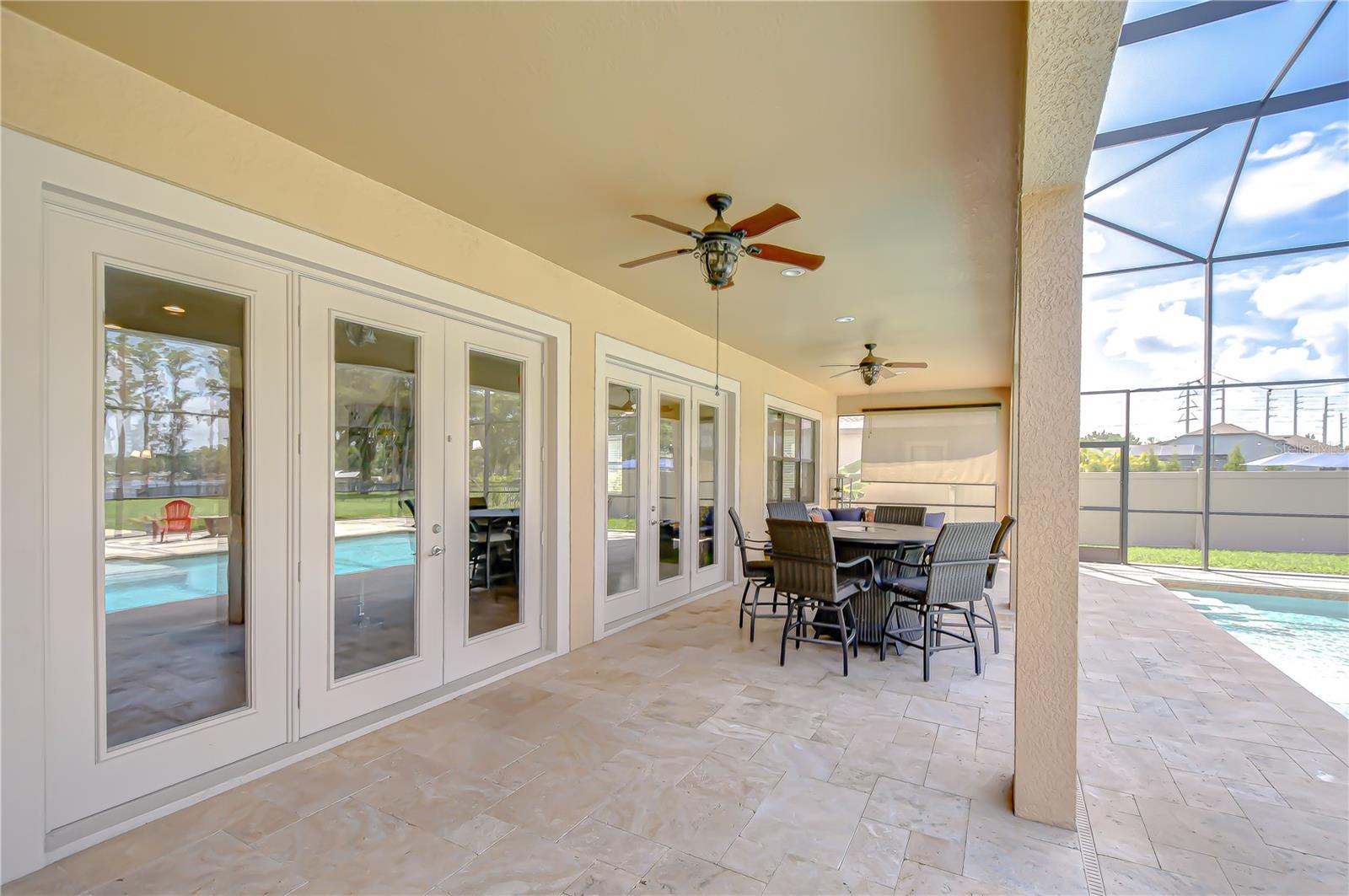 The first floor covered patio spans the width of the pool area.