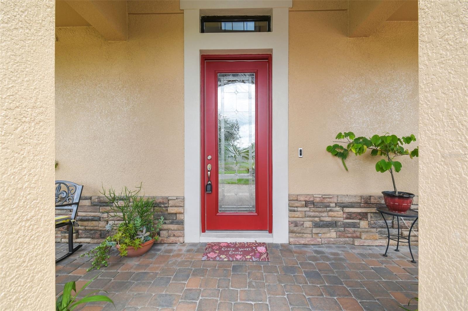 A designer glass entry door greets you at the covered front porch.