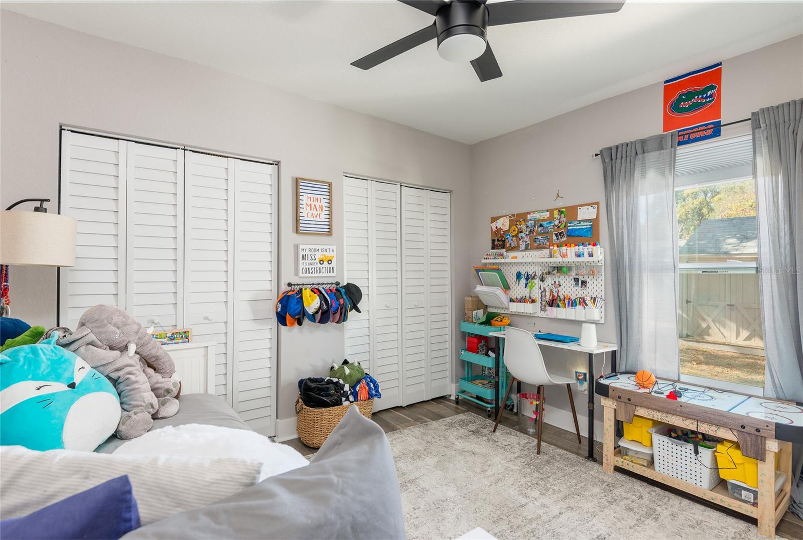 Bedroom 2 with ceiling fan and dual closets