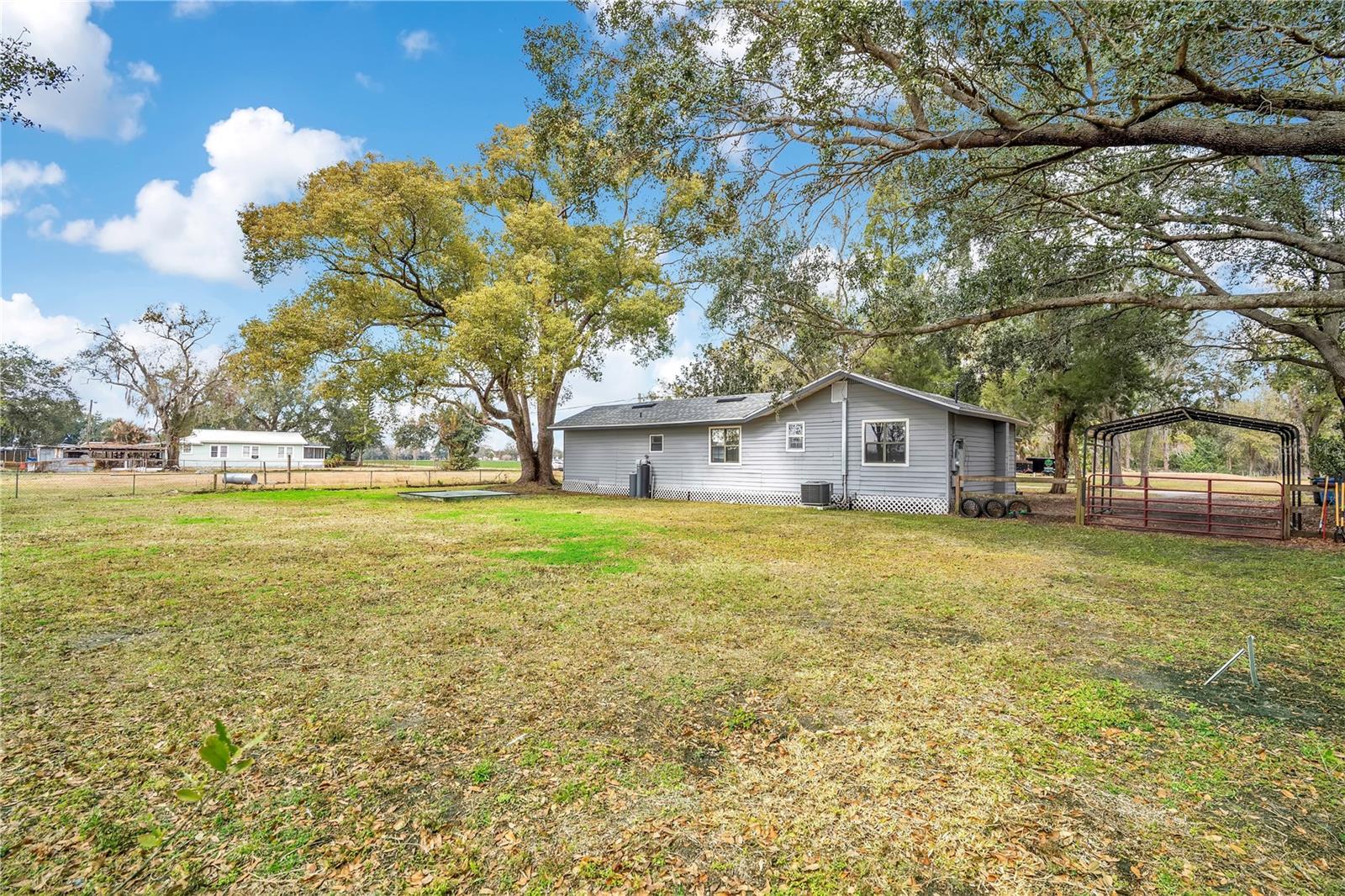 Back of house, car port, backyard.
