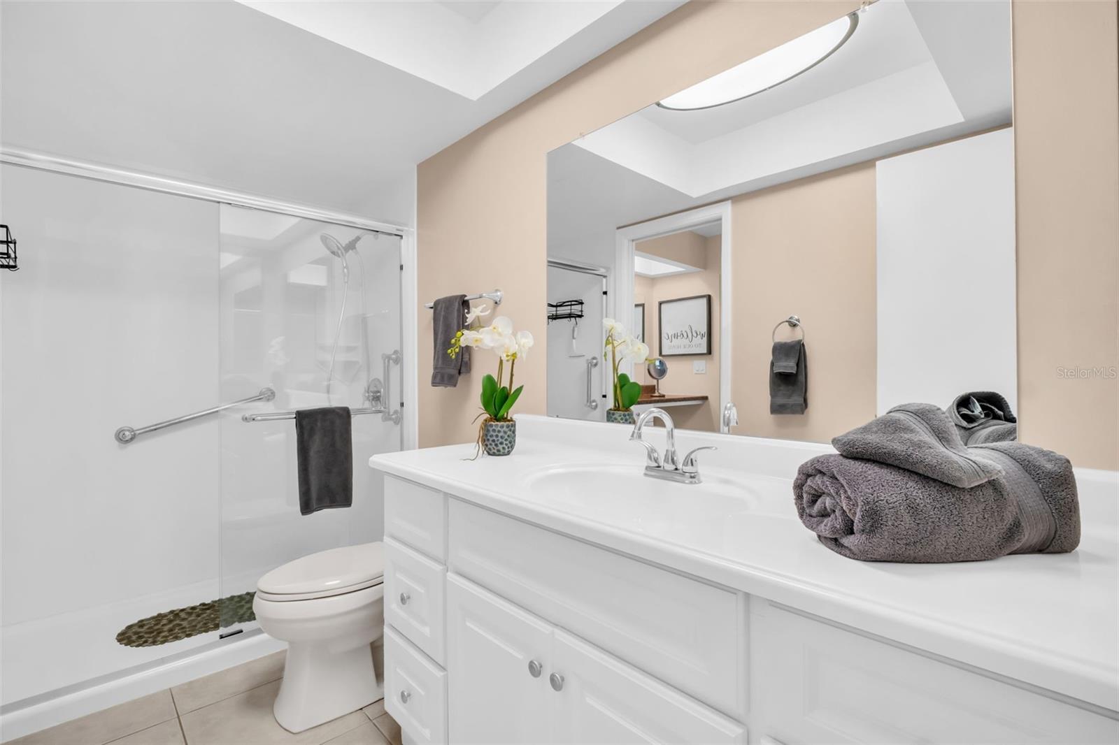 Updated bath with walk-in shower & sturdy glass sliding door~