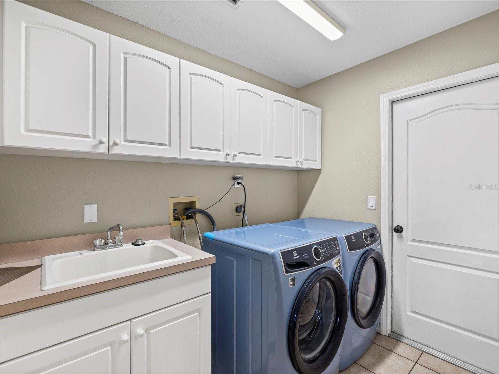 Laundry room on the main floor between kitchen and garage