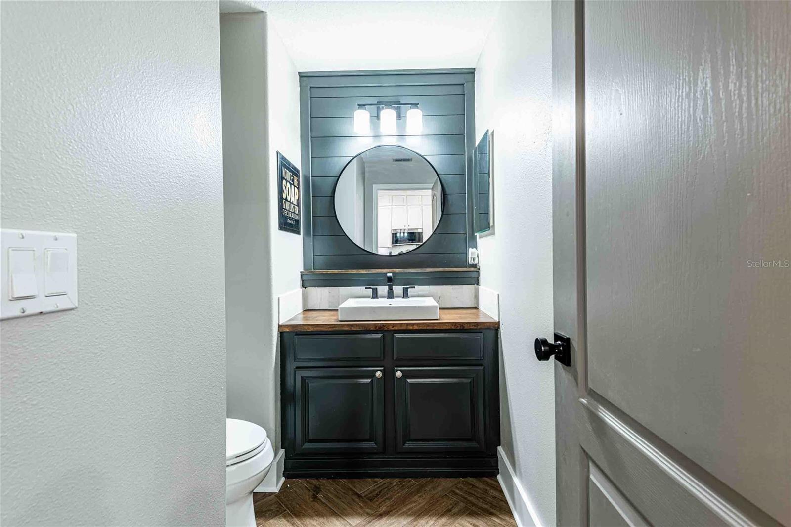 Half bathroom located off of the kitchen on the 2nd floor