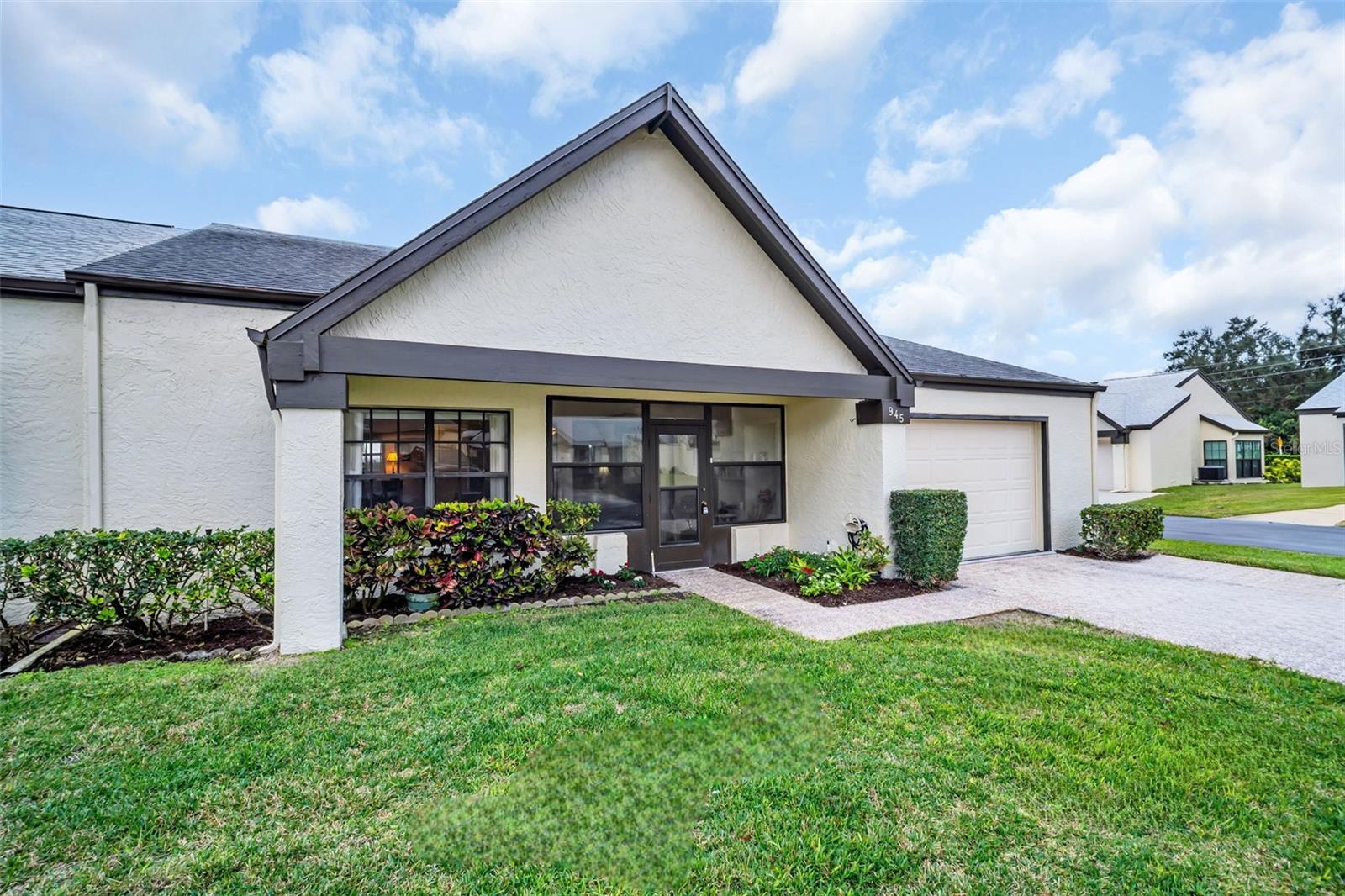 End villa safely high & dry above the flood plain, concrete block construction, and widened 2-car driveway~