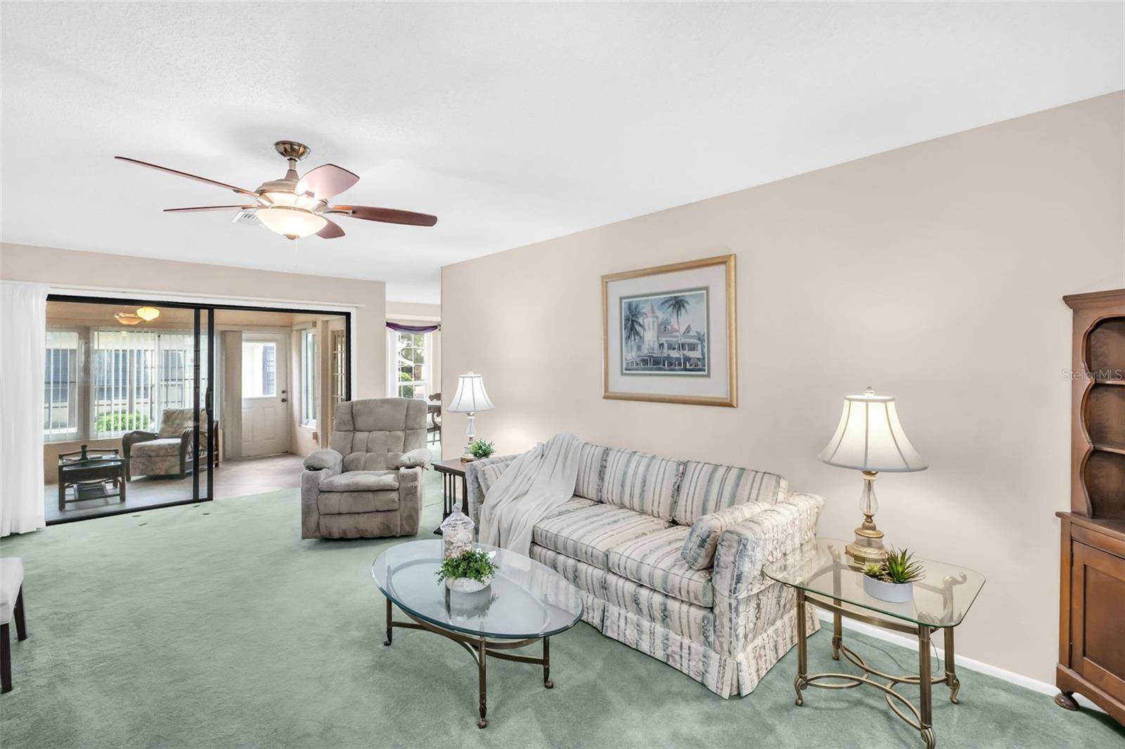 Open & airy upon entry with newer carpet, neutral color paint, and updated fan/fixture~