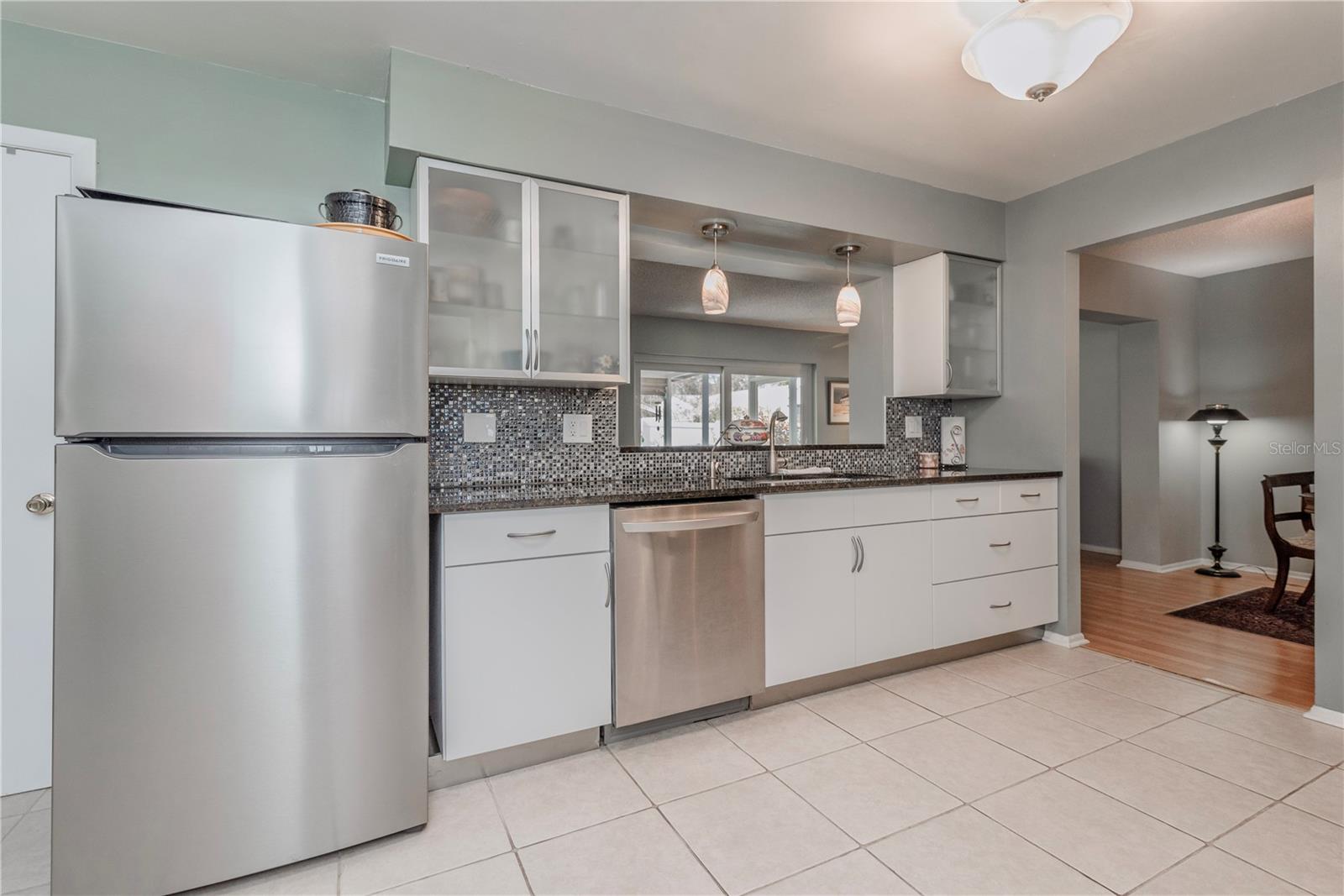 Kitchen with glass front upper cabinets.