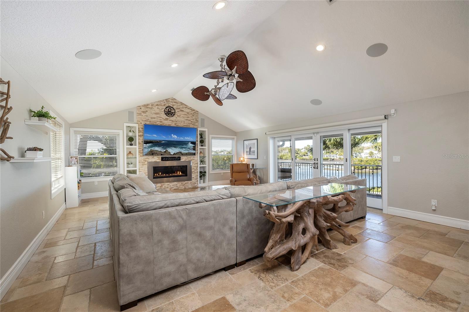Travertine stone floors, gas fireplace and cathedral ceilings.
