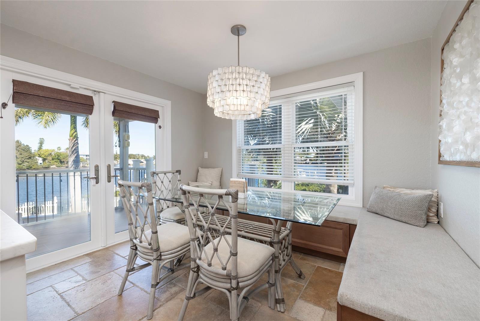 Bench style kitchen table, sliders open to Trex covered balcony and stairs go down to pool level.