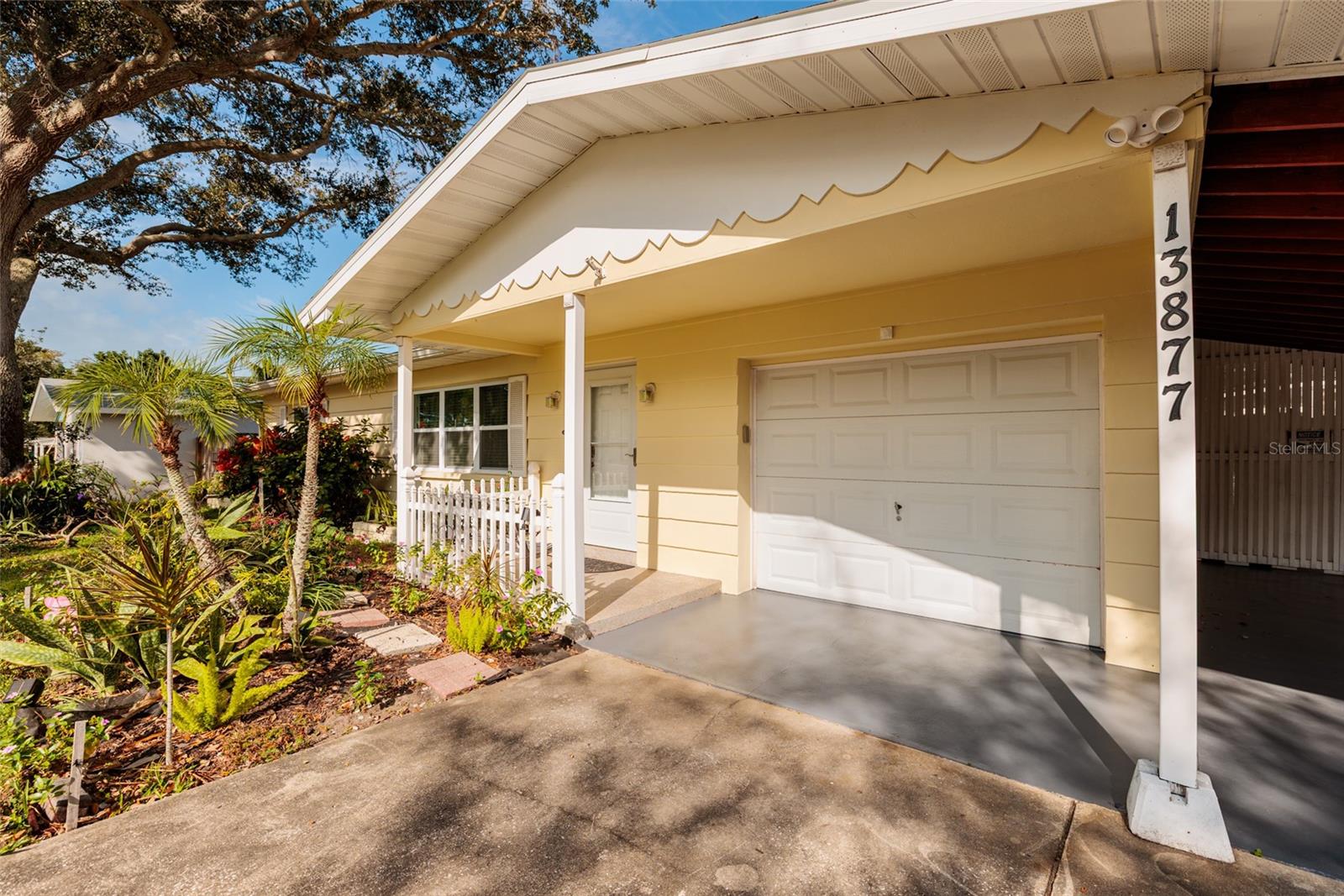 Adorable yellow house with a white picket fence