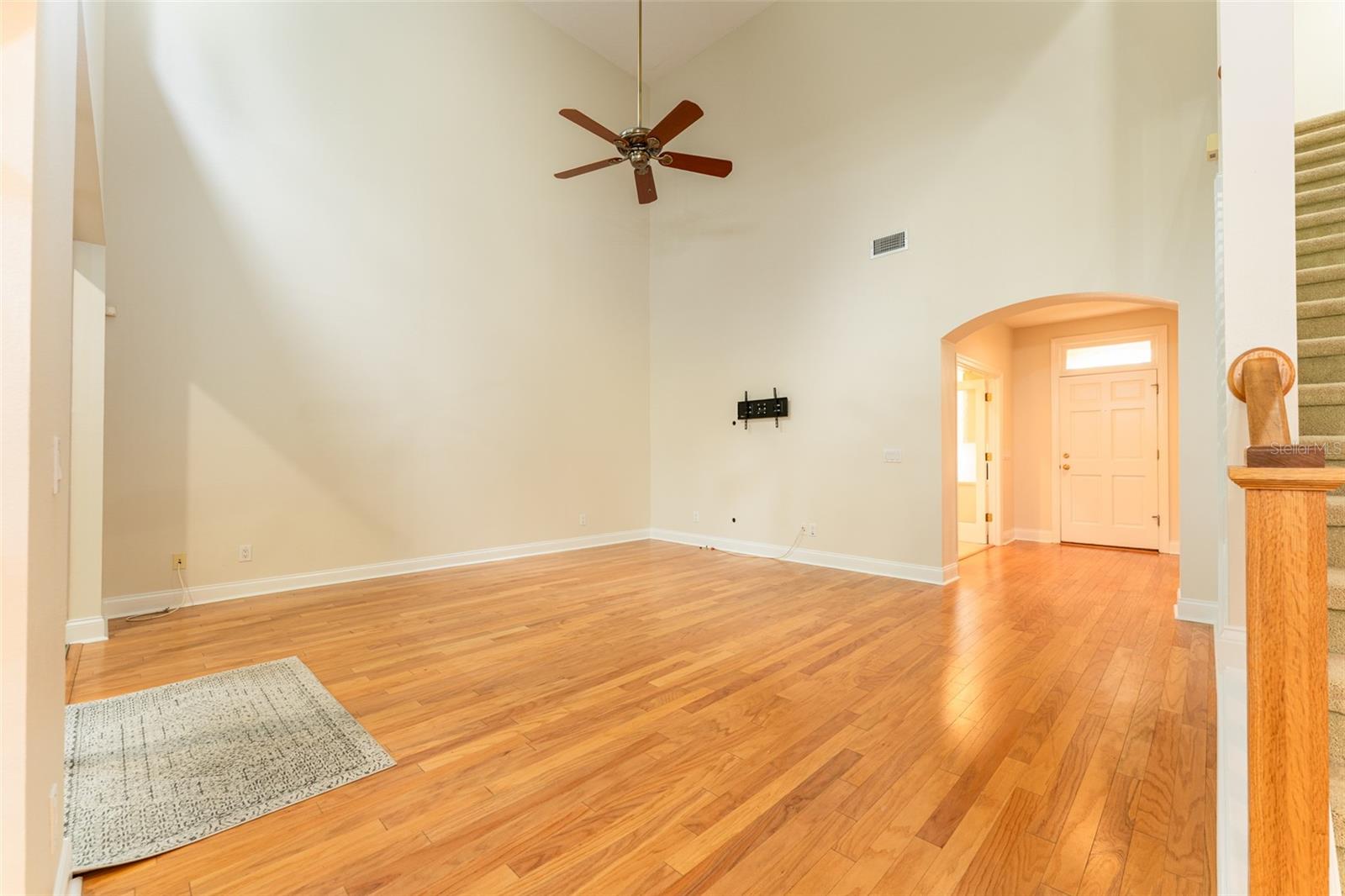 Virtually Staged Light Infused Great Room with Real Hardwood Flooring & Soaring Ceiling