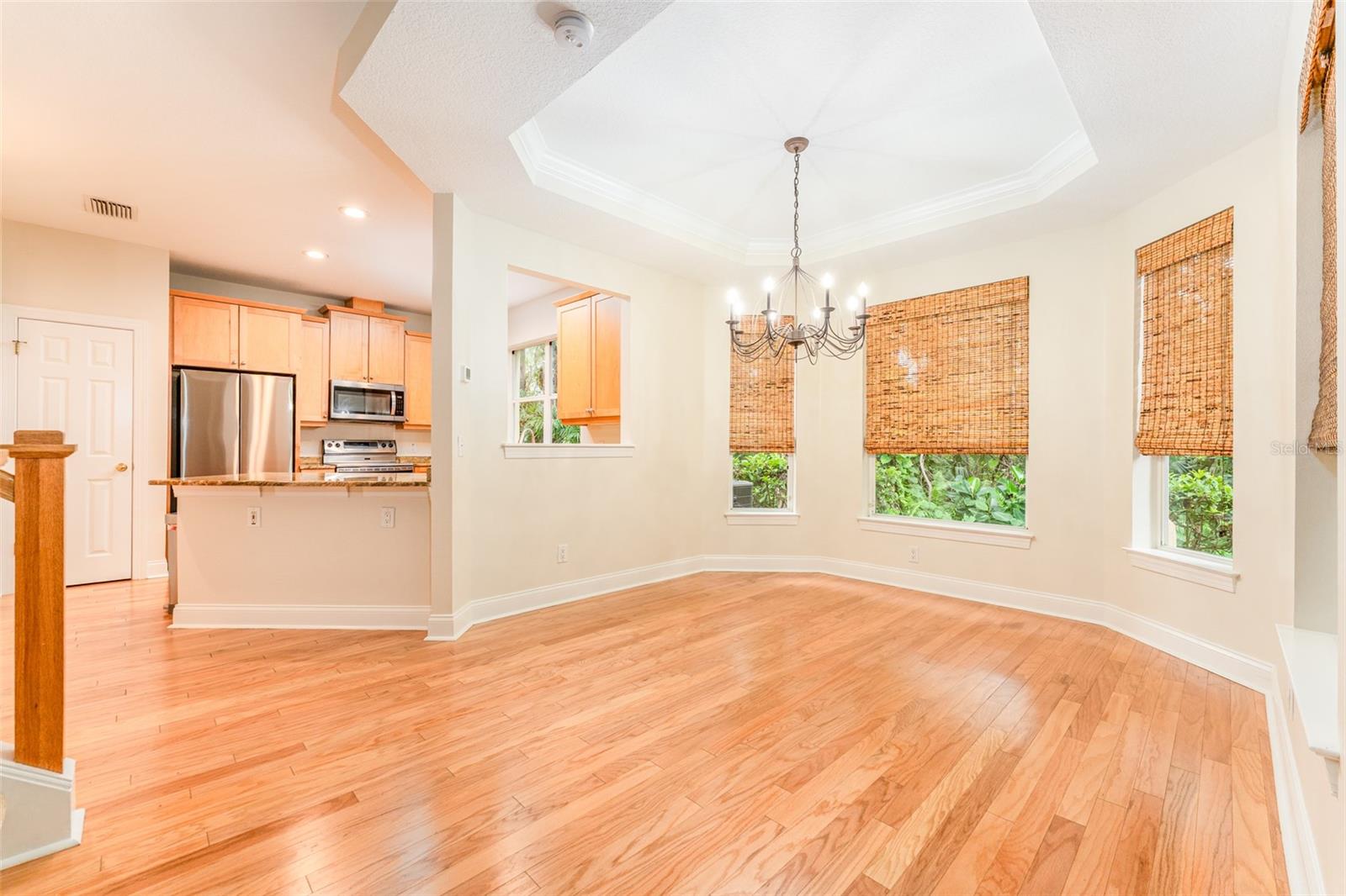 Cozy & Spacious Dining Area with Bay Windows, Coffered Ceiling & Crown Molding