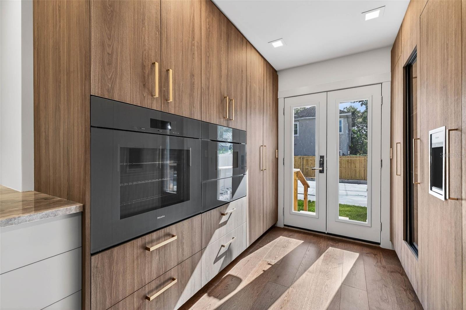 Ample storage around the Miele ovens and microwave