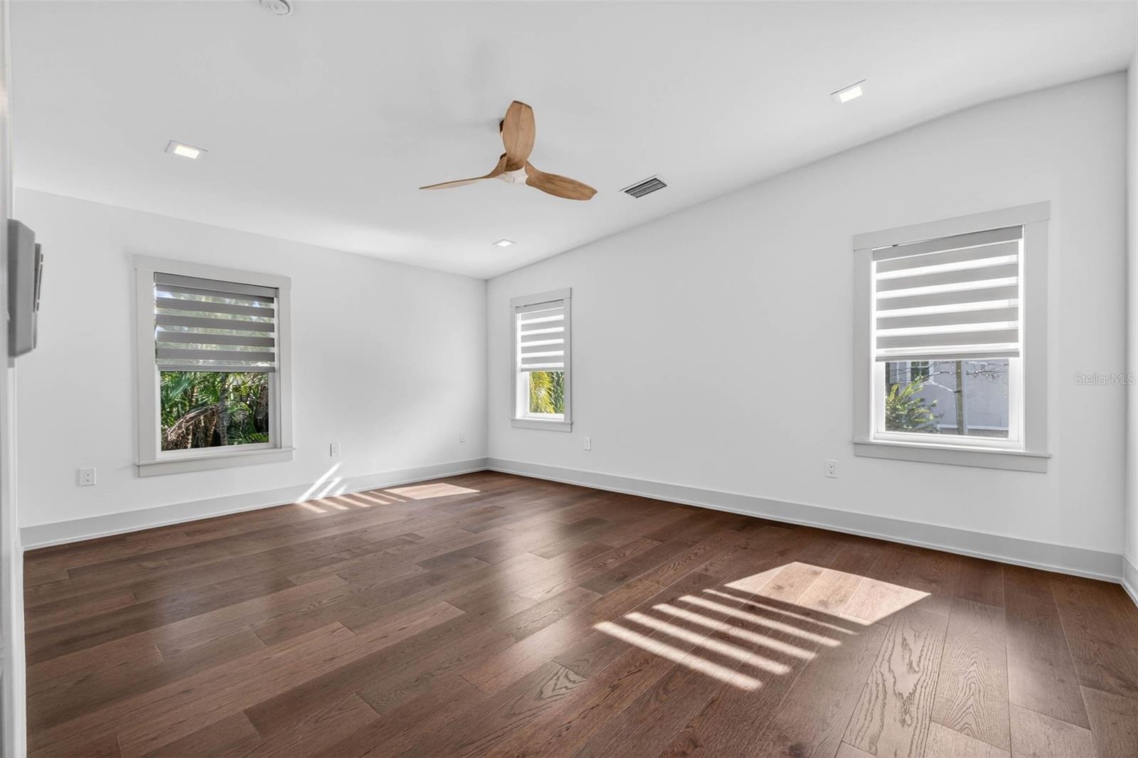 Main bedroom with high ceiling, ensuite bath, and custom walk in closet.