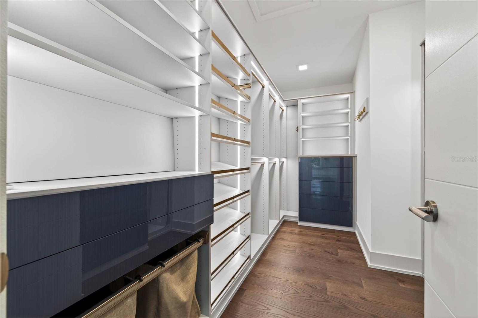 Spectacular ensuite walk in closet with everything you could want in your private space including custom lighting.