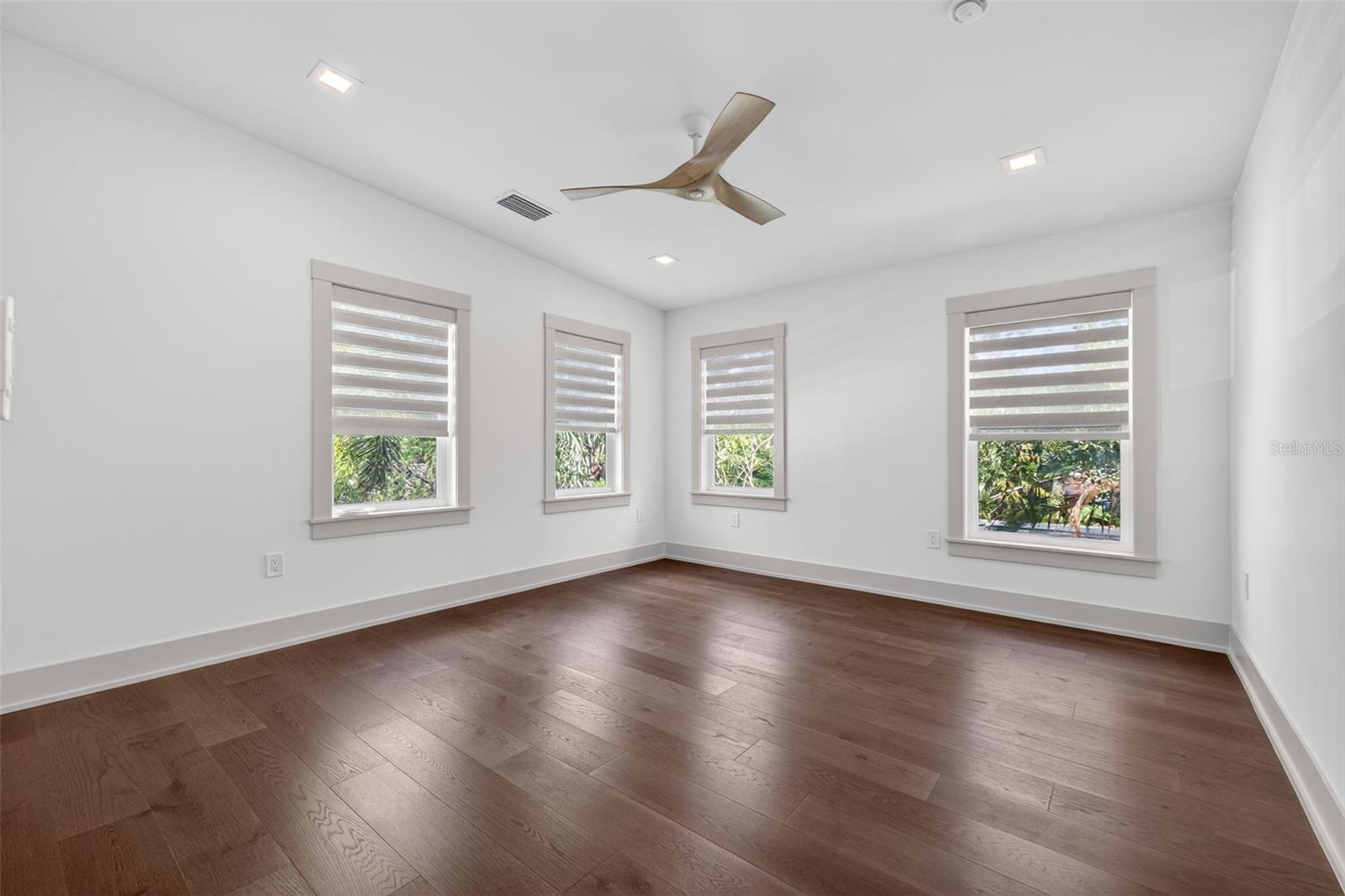 Bedroom number three with remote window treatments