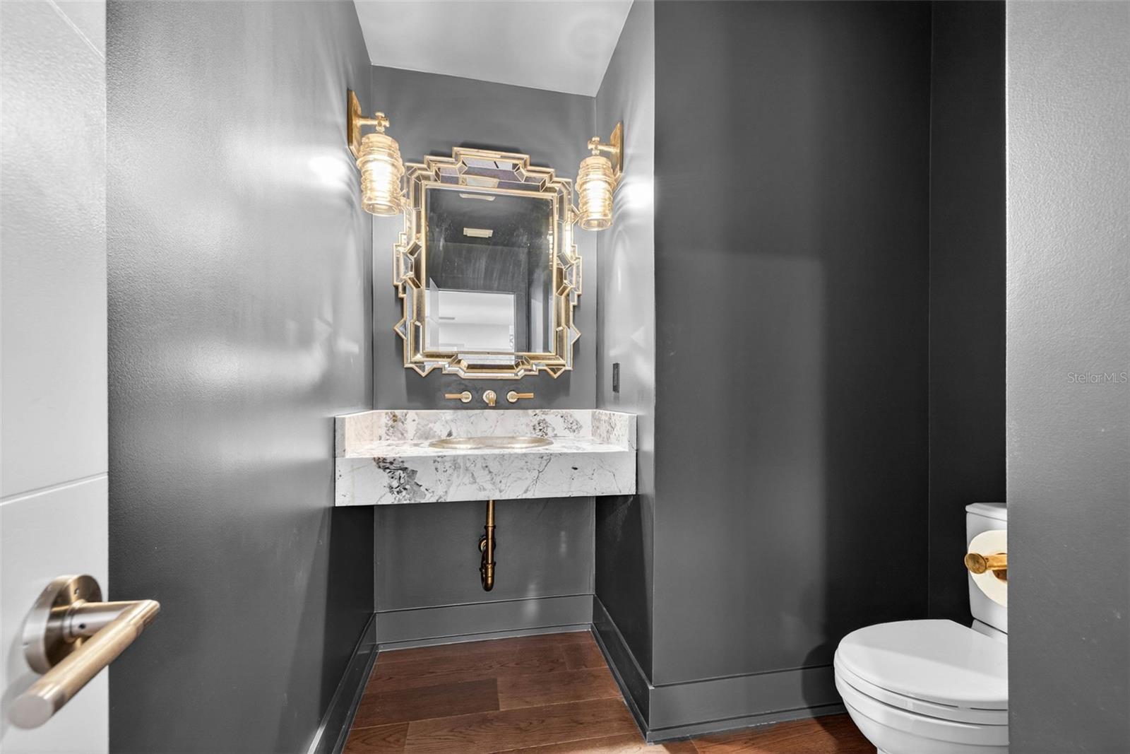 Downstairs guest bath with designer scones, stone counters, and masterful details!