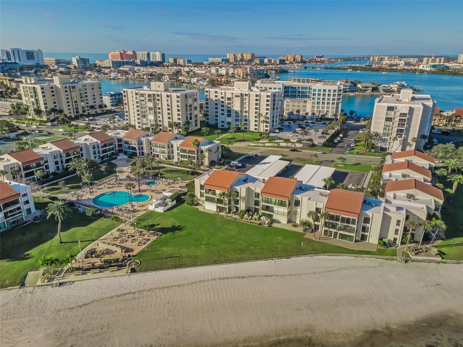 Clearwater Point overview with large pool & spa, grill area, beach