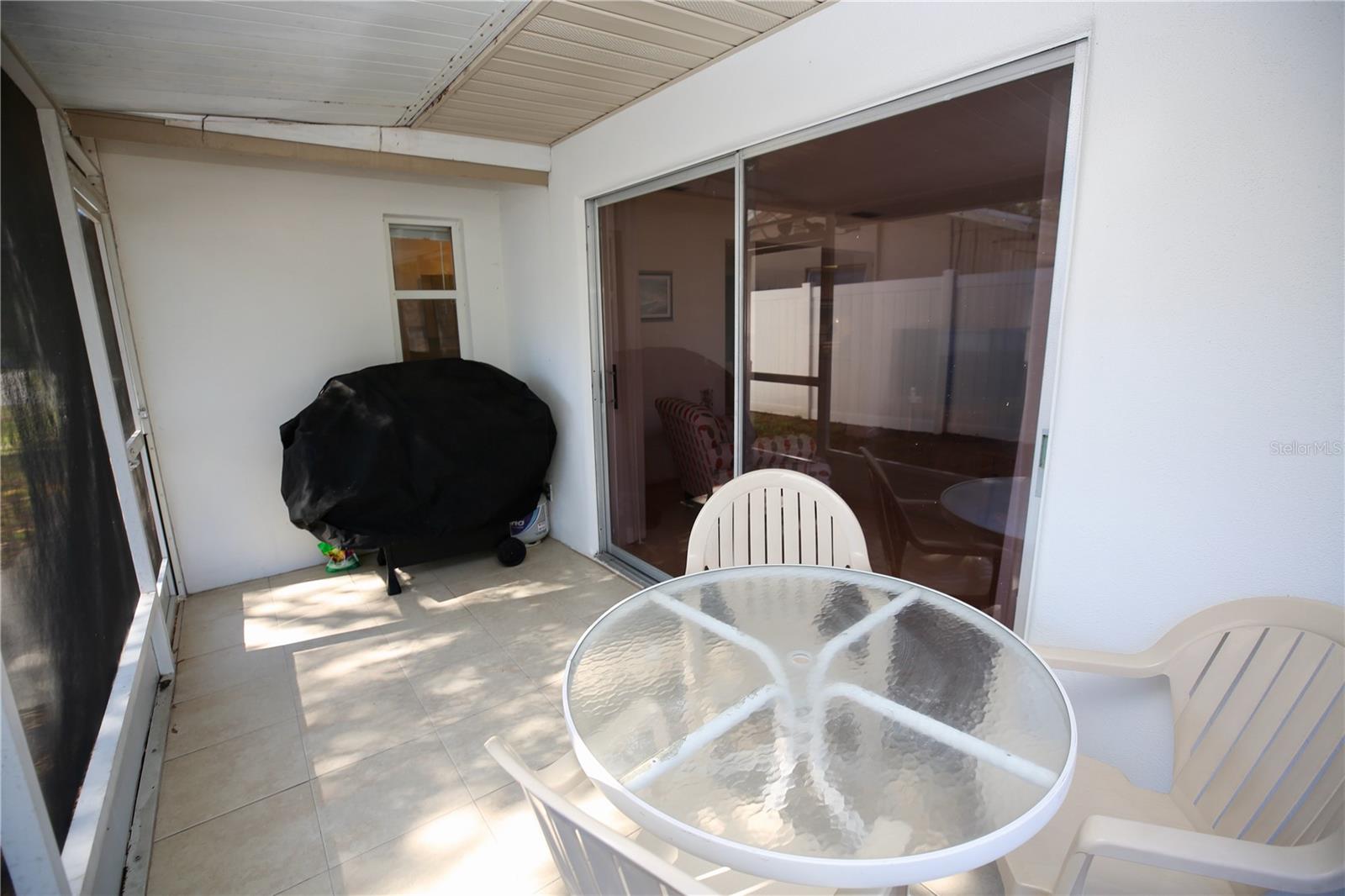 Enclosed porch on the side of house - perfect for grilling!