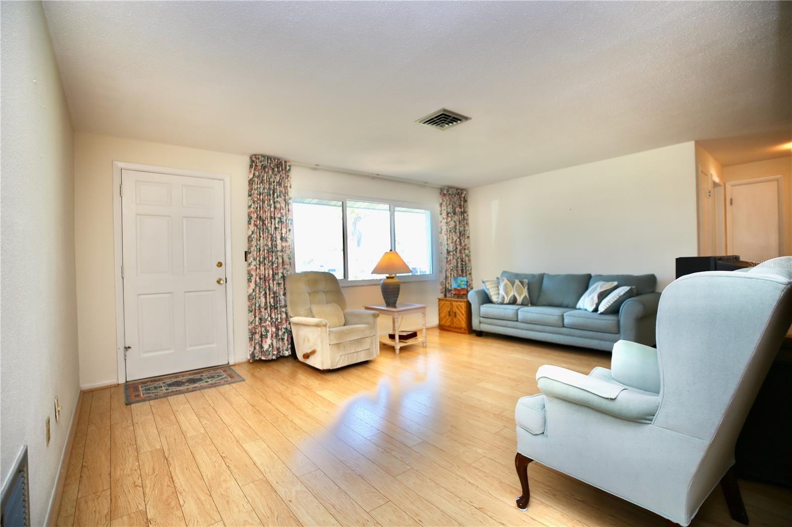 Spacious living room with natural light from newer windows
