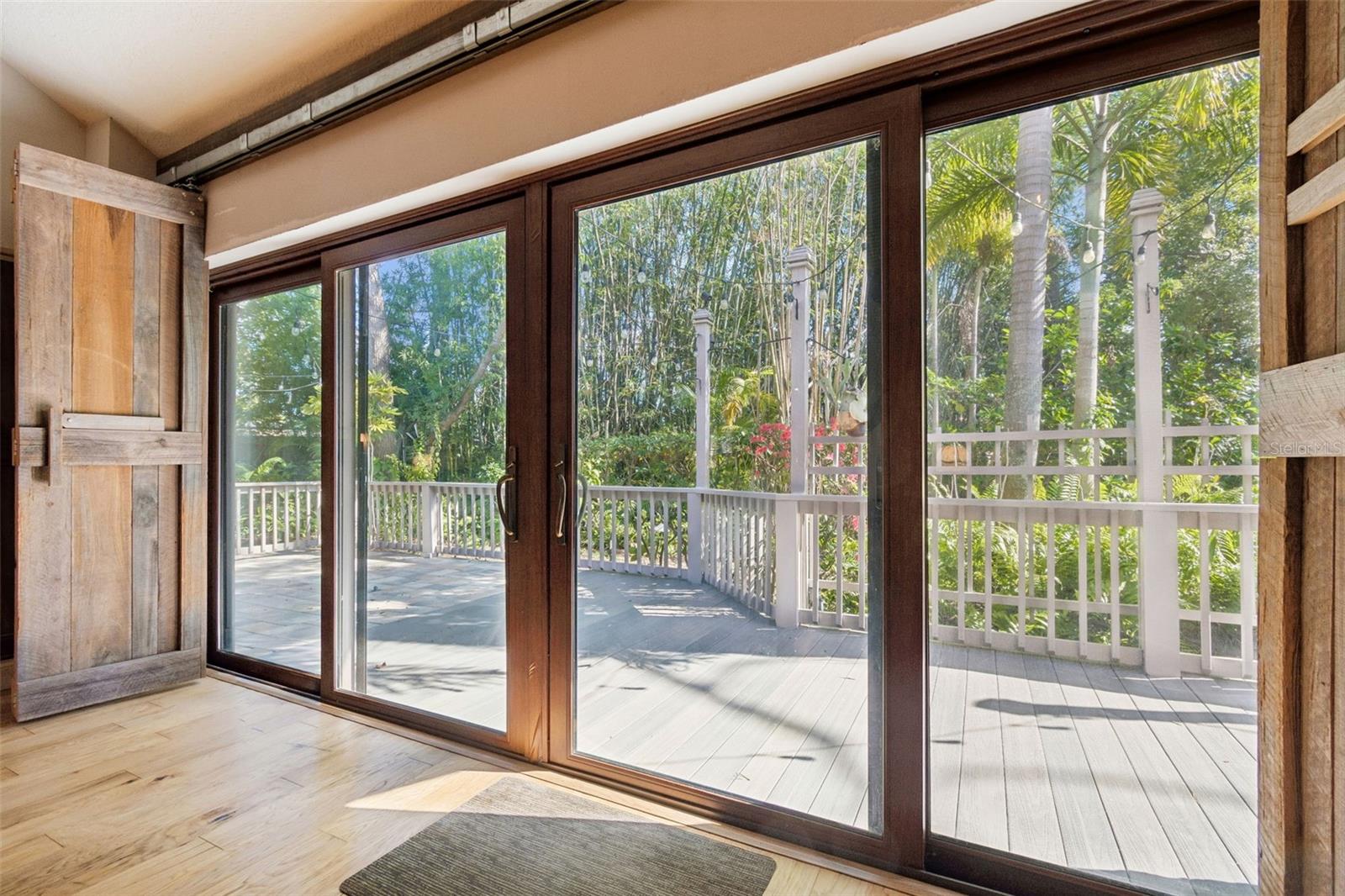 Wall of sliders to private wooded deck area