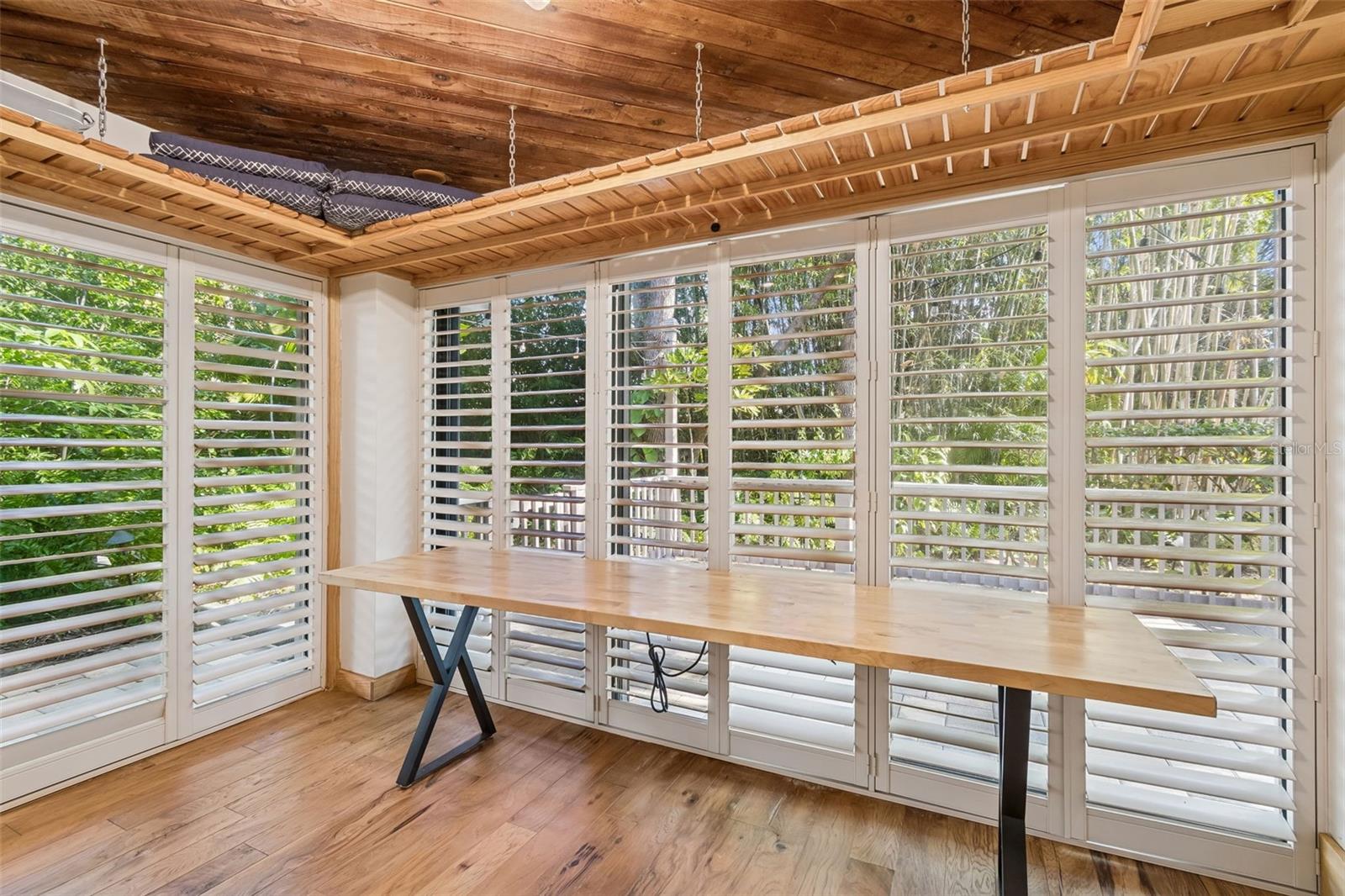 Breakfast/Sun room with sliders on each wall to outside
