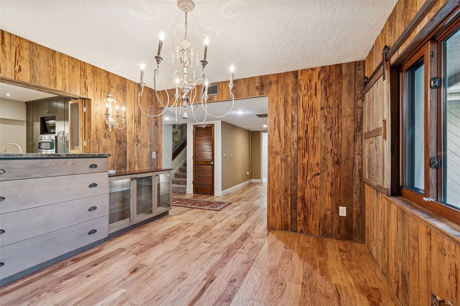 Dining with big window, built-ins and pass-thru from kitchen