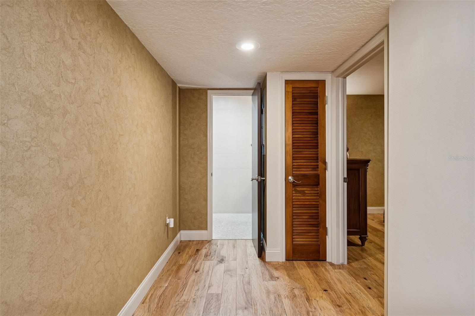 Hall to right of front door looking to bathroom and bedroom