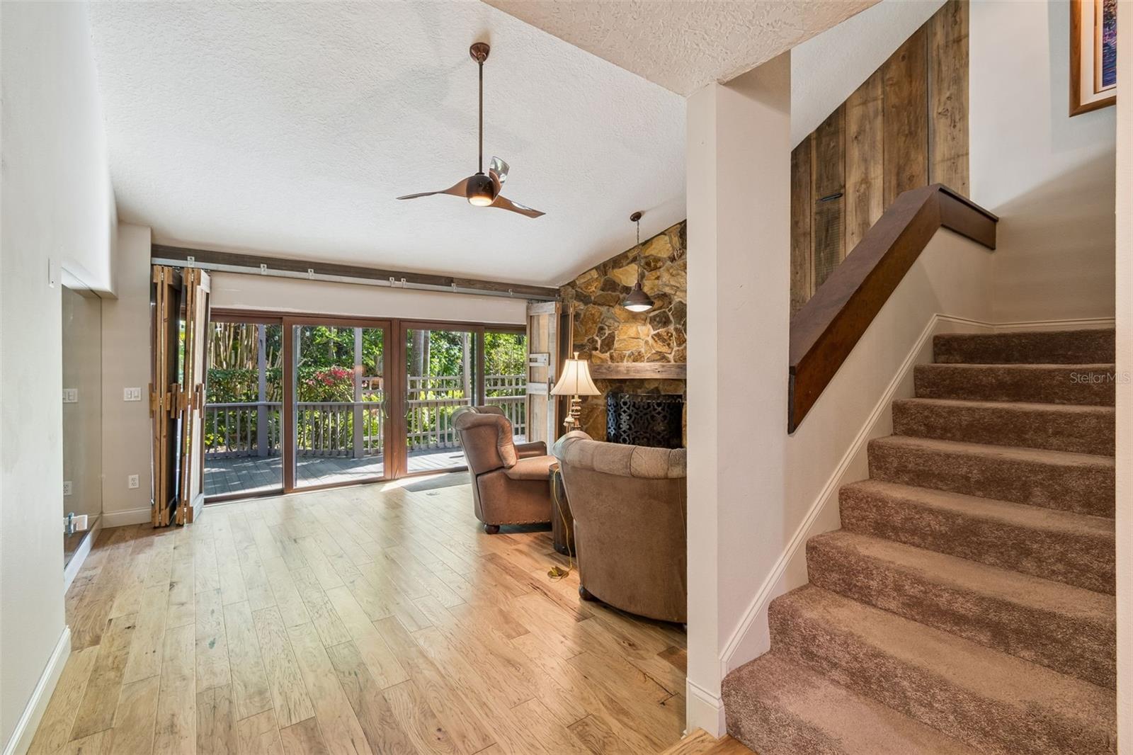 Family room and stairway.  1 bedroom on 1st and 2 upstairs
