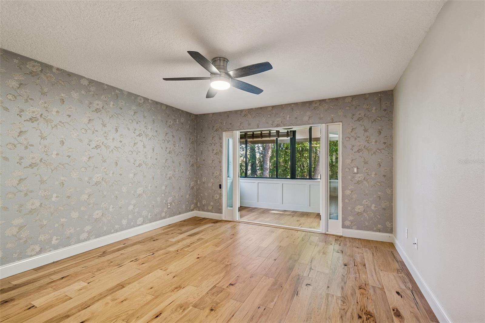 Main bedroom with doors to sun/sitting room