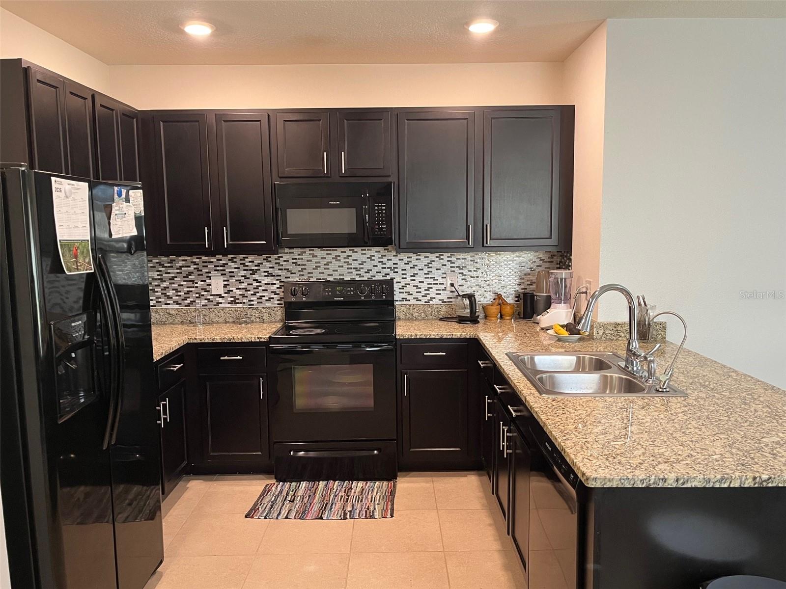 fully equipped kitchen with granite countertops