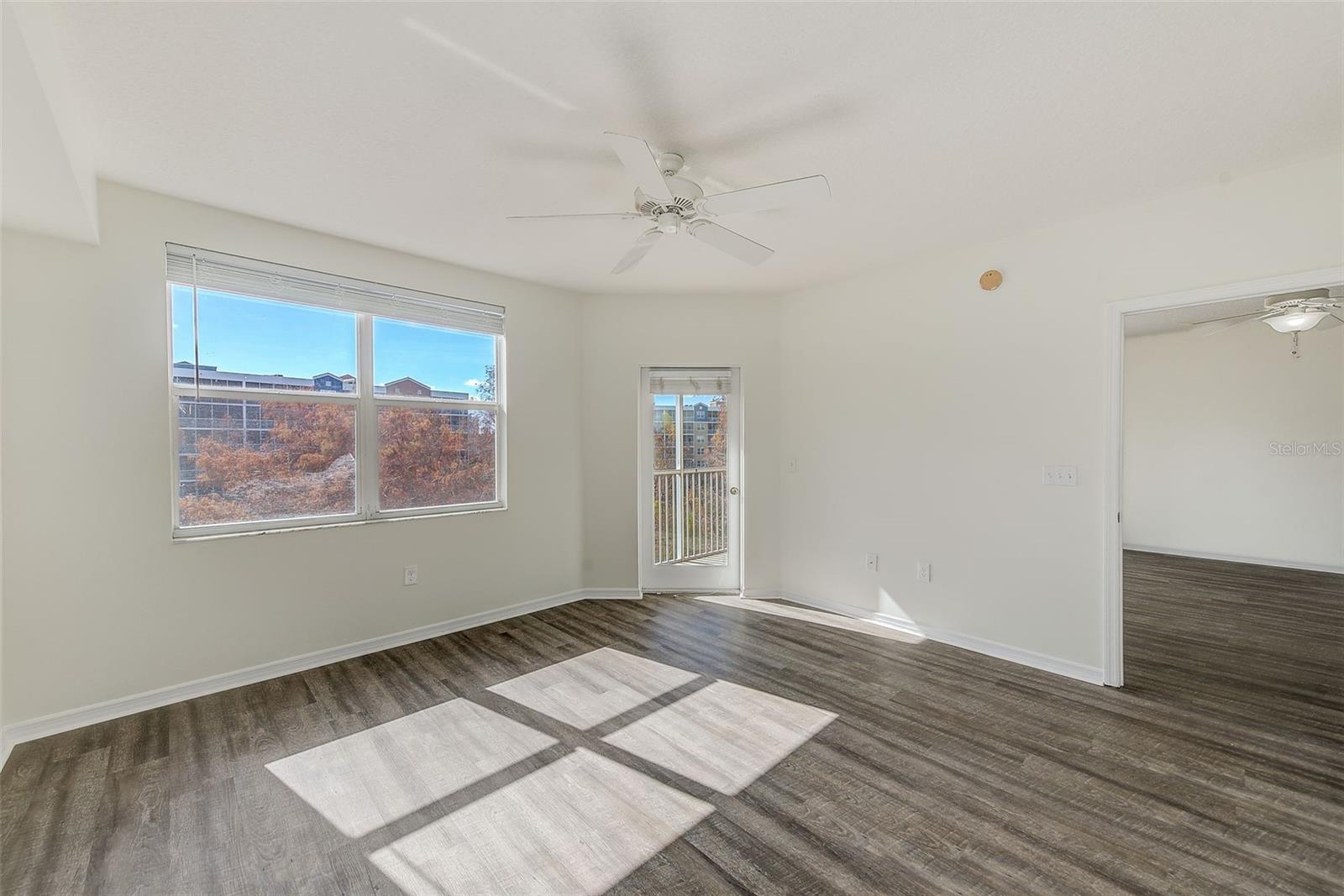 View of master bedroom with door leading to lanai and living room