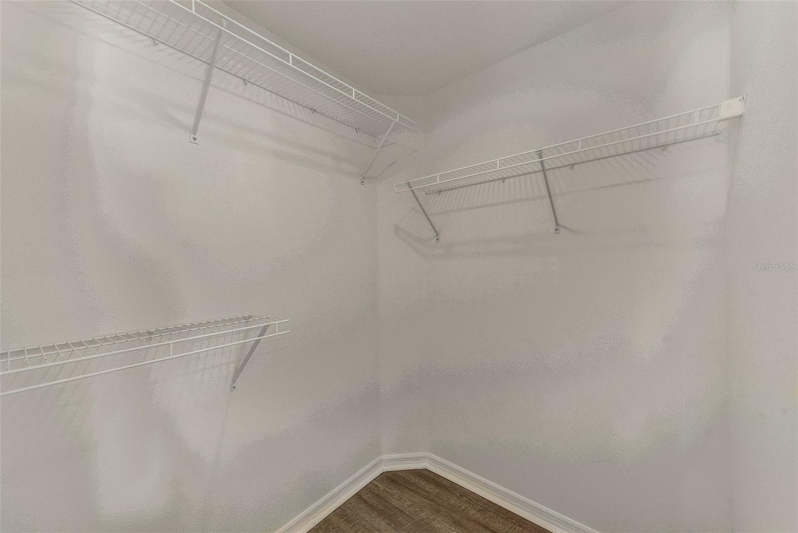 View of walk in closet in master bedroom