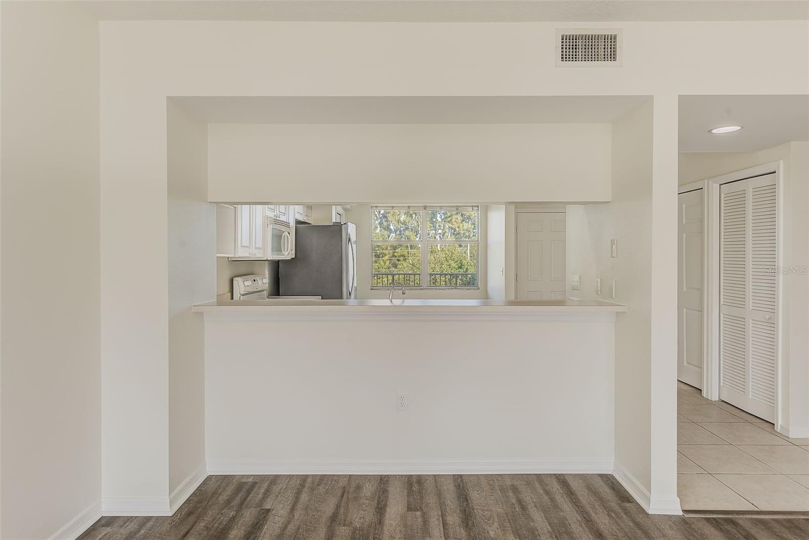 View of pass thru window from kitchen to living room