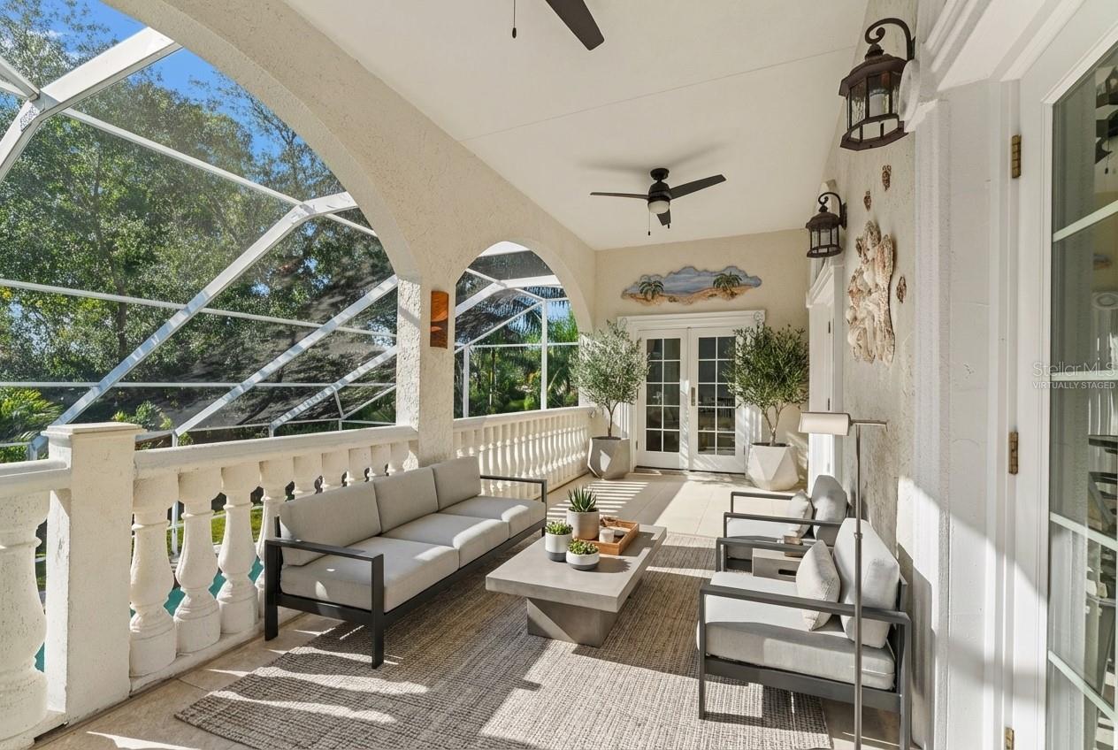 Rear Balcony off Family Room overlooking pool Virtually Staged