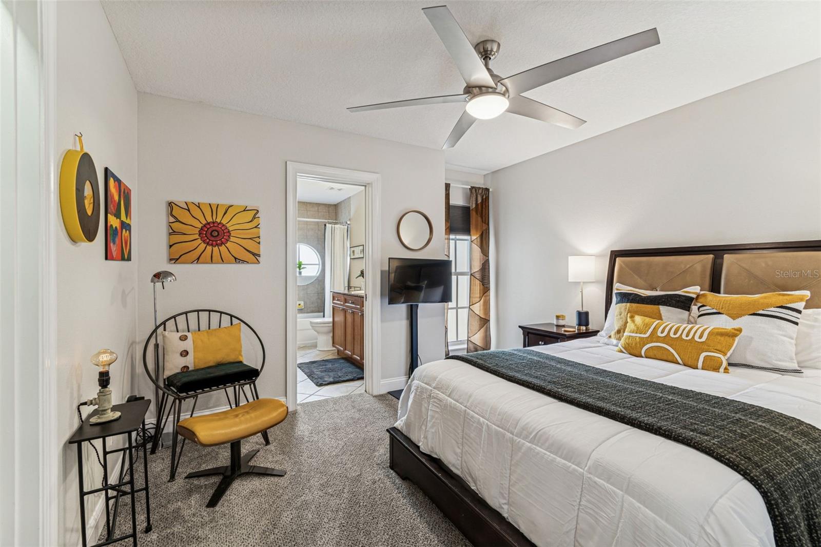 2nd bedroom with queen size bed, reading area and walk-in closet. Window has an according style hurricane shutter. Jack and Jill full size bath.