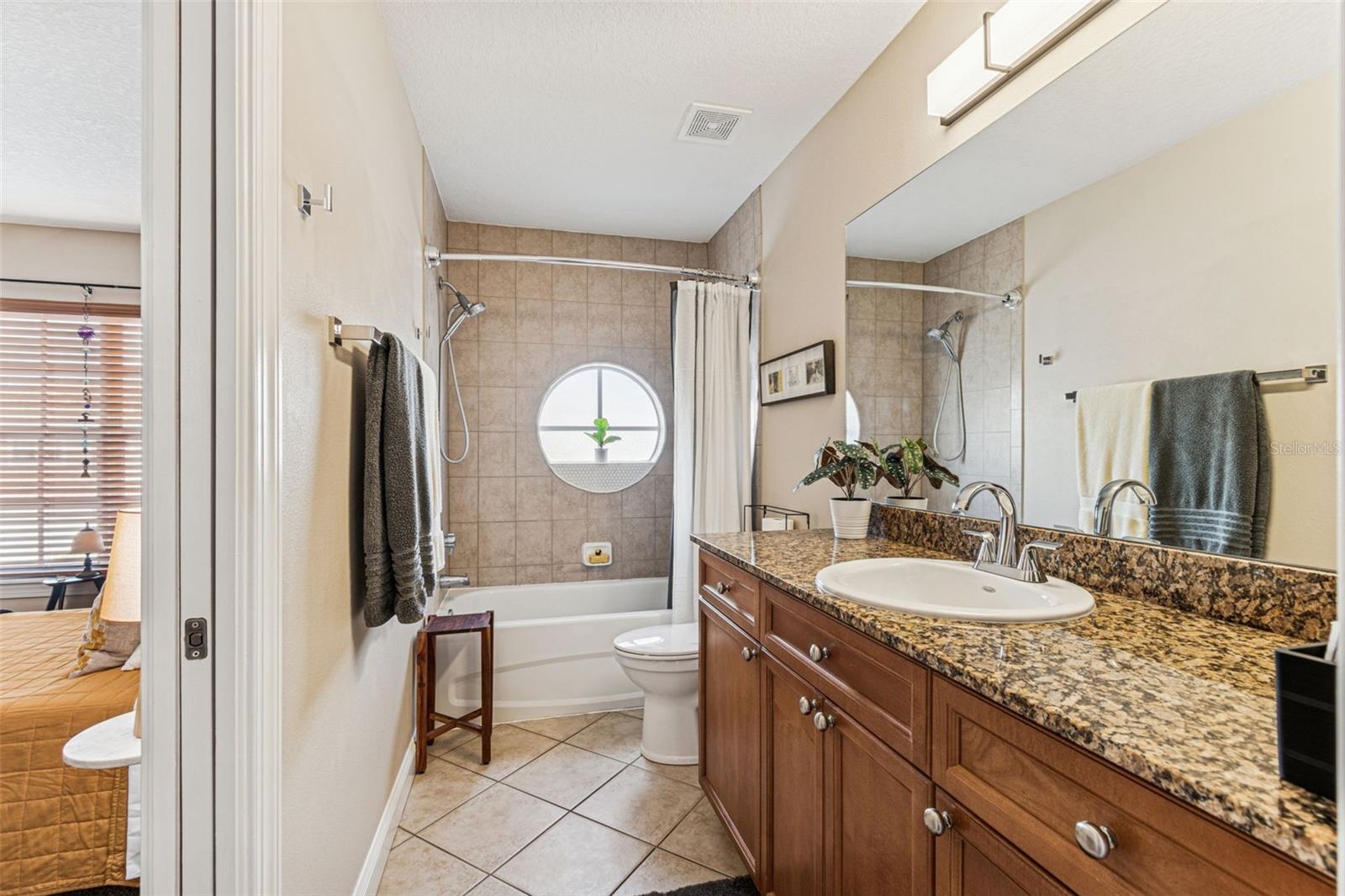 Spare bath with newly tiled circular hurricane window