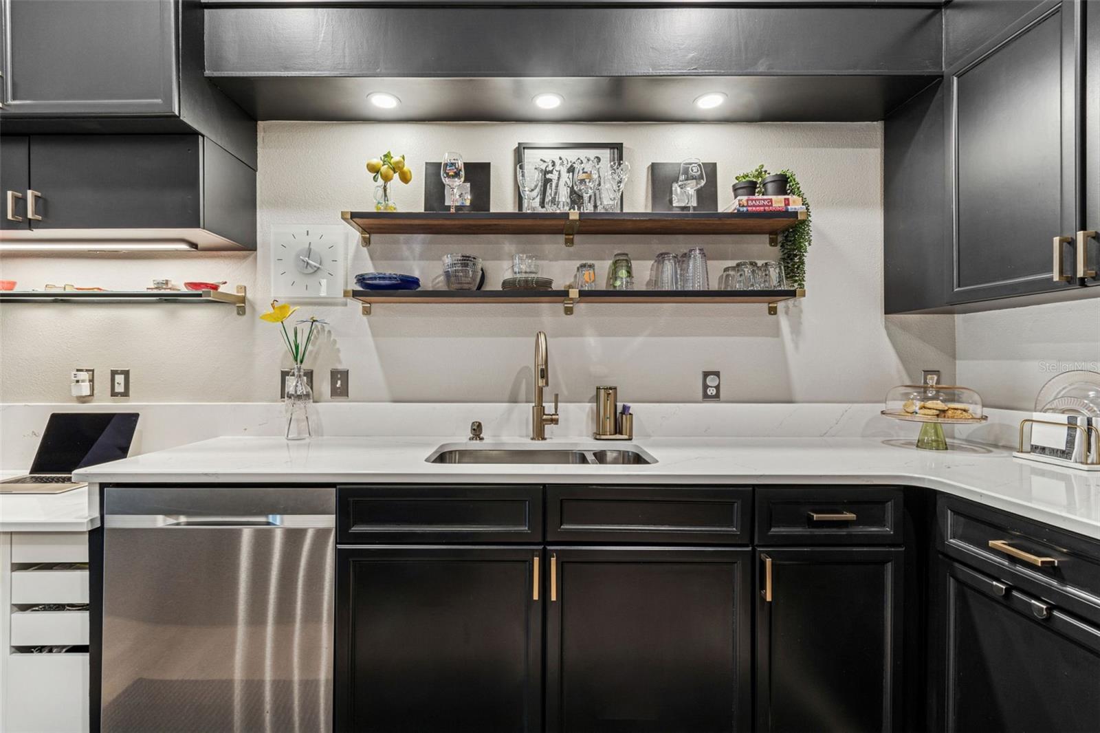 Open shelves, dimmable lighting, custom quartz with gold and gray veining.