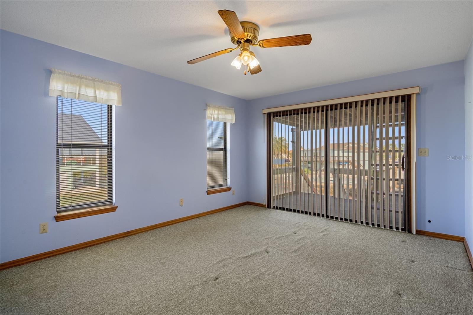 Primary Bedroom with Sliders to Lanai Overlooking Canal