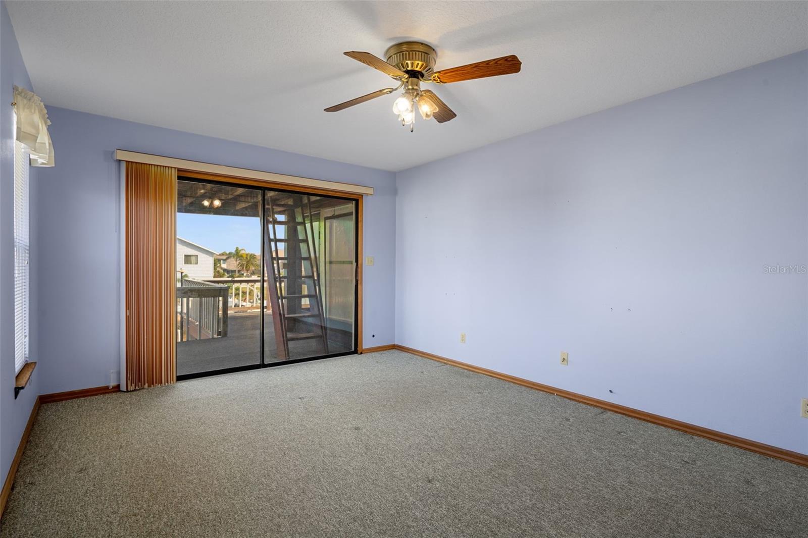 Primary Bedroom with Sliders to Lanai Overlooking Canal