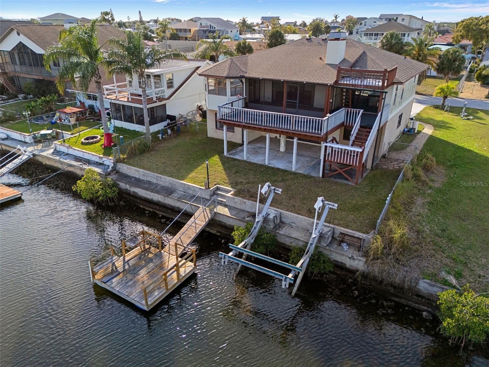 Rear of Home with Seawall, Floating Dock, and Boatlift