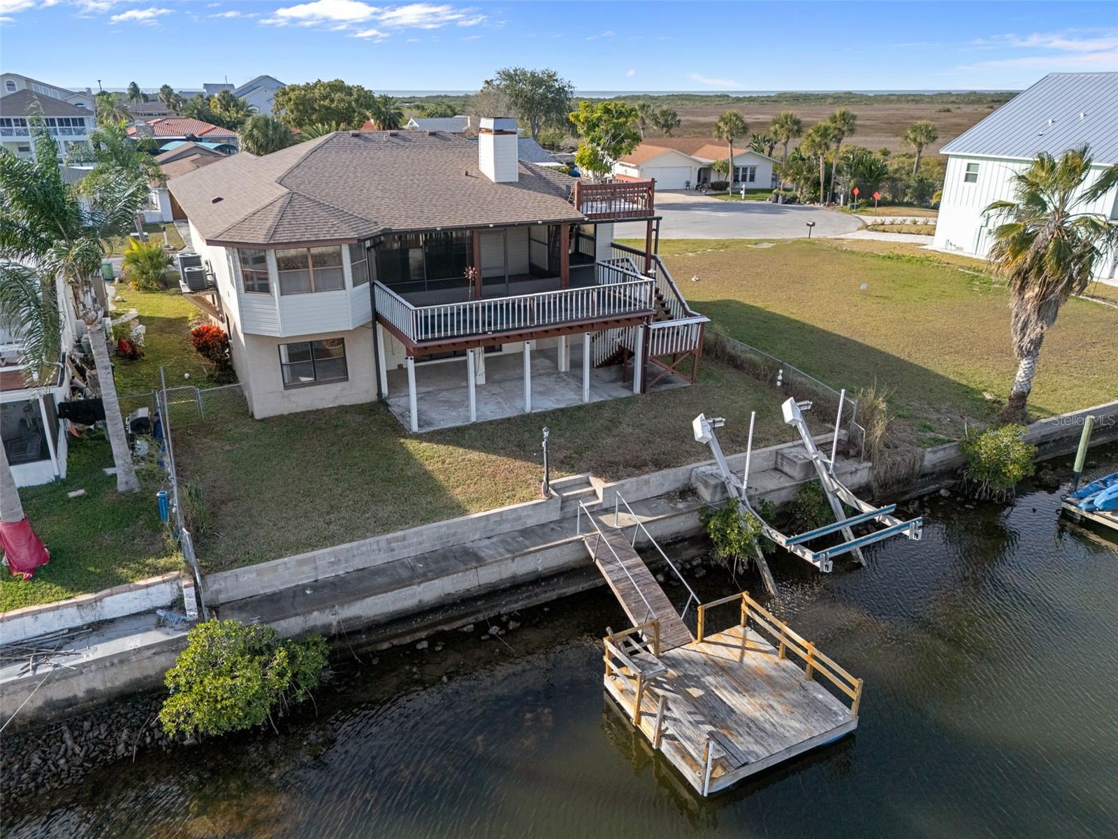 Rear of Home with Seawall, Floating Dock, and Boatlift