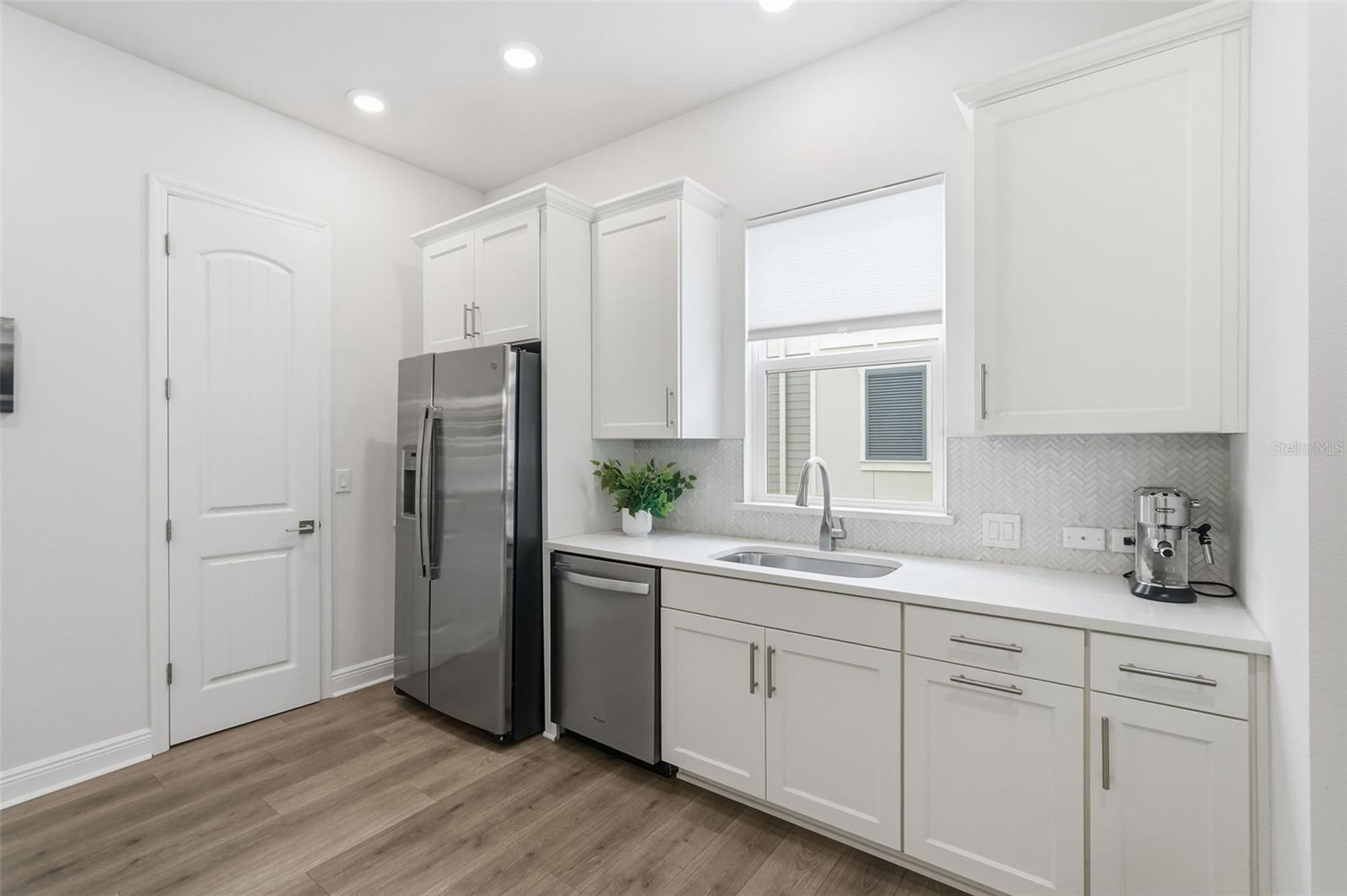 View of kitchen, with pantry behind door to the left in this photo.