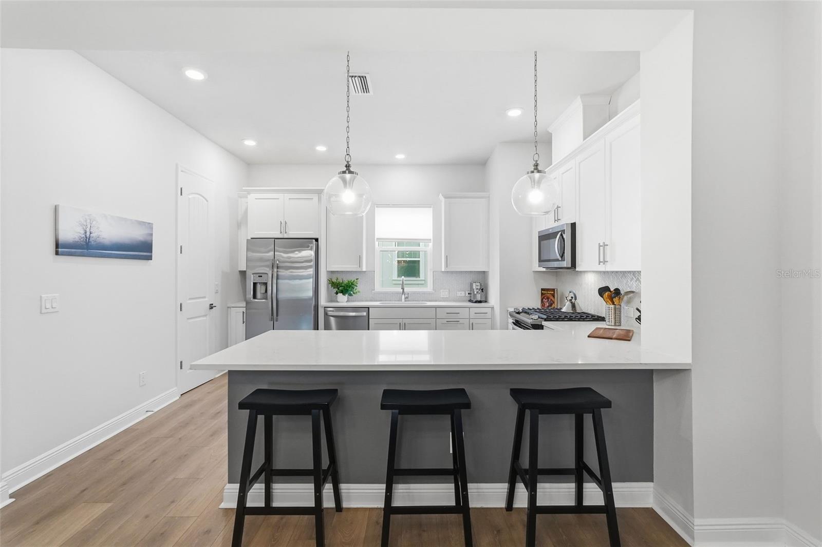 Kitchen offers bar seating.