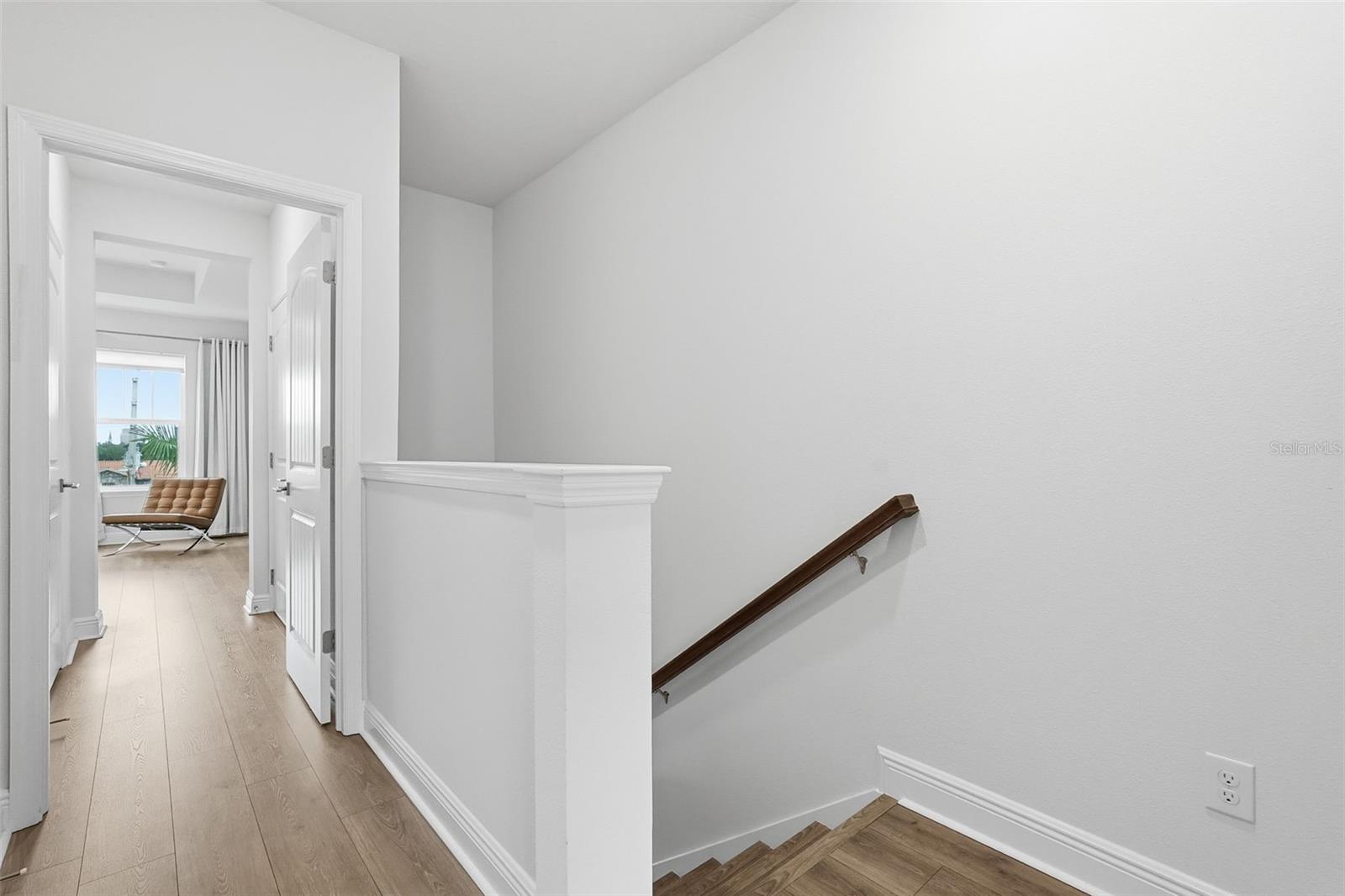 Third floor view with master bedroom in the background... the other bedroom suite is located on the opposite side of hall, and laundry closet is positioned between the rooms.
