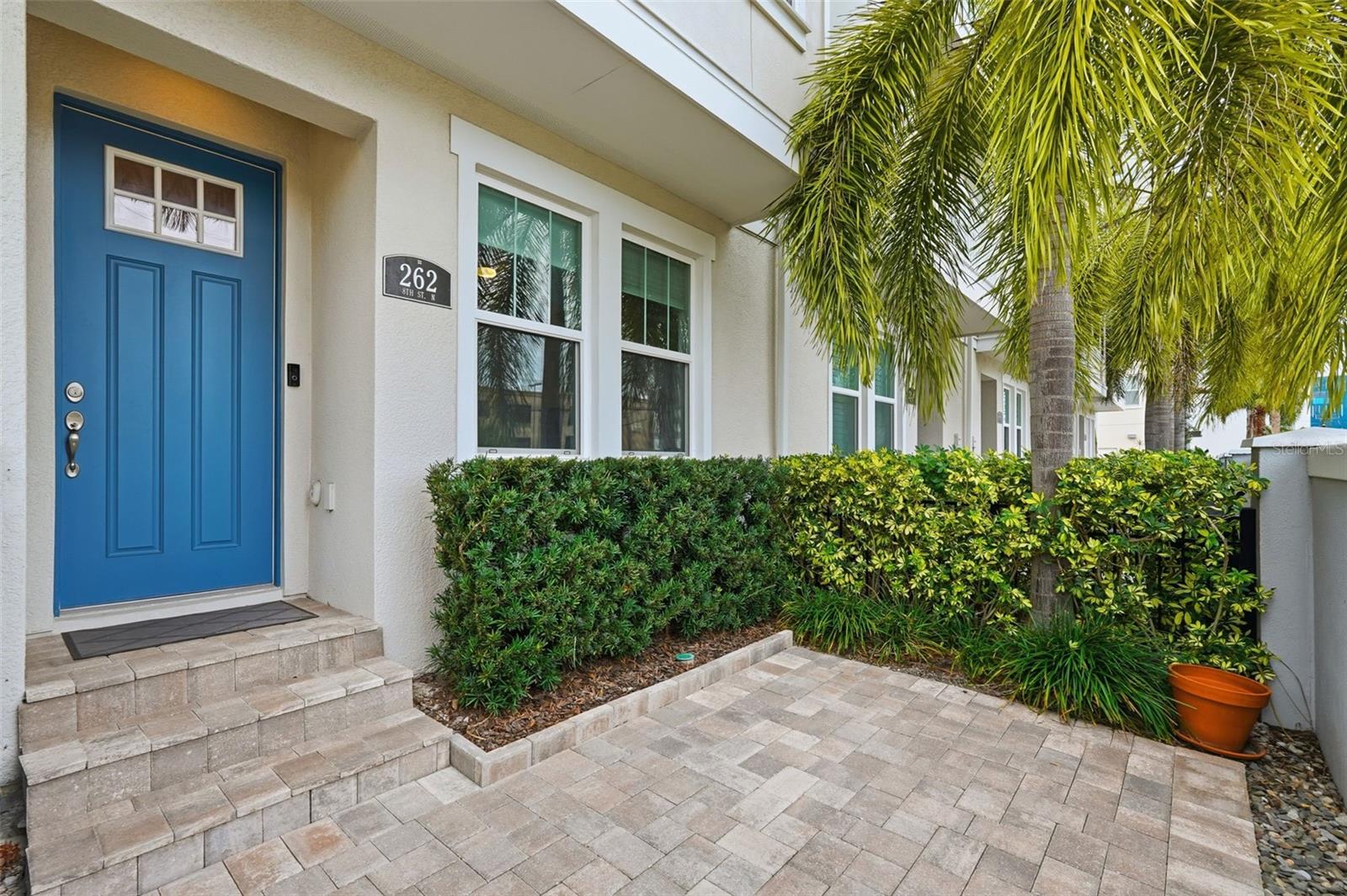 View of front door and charming, gated courtyard.