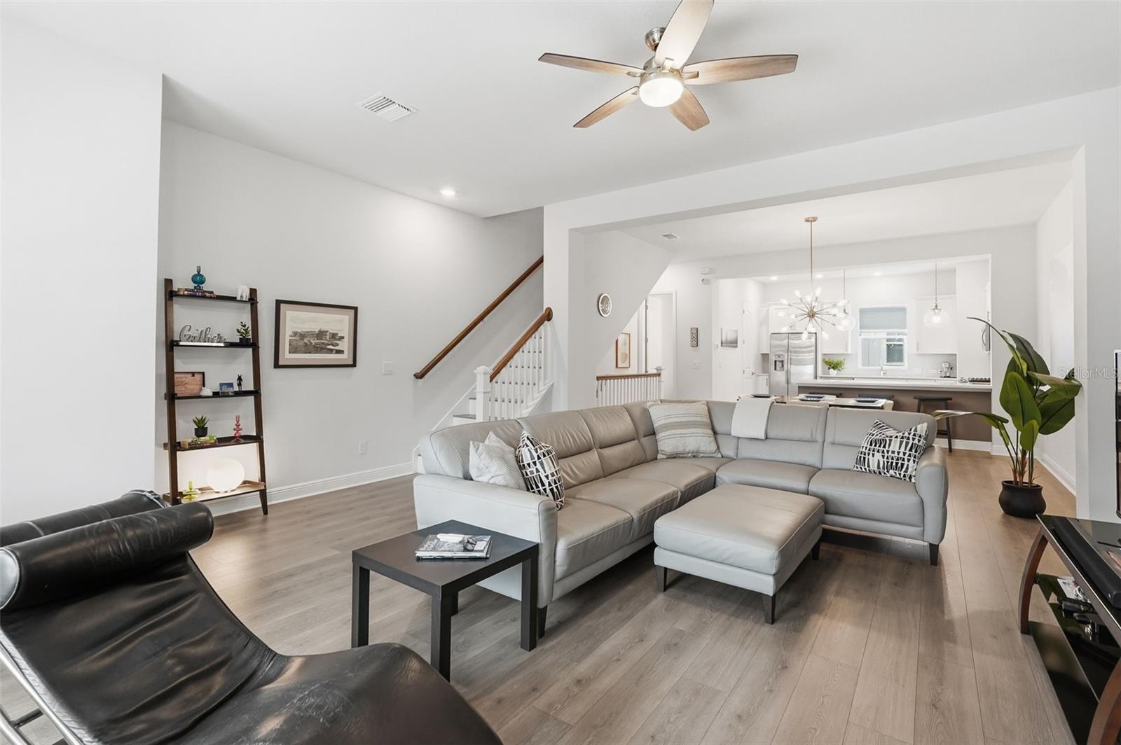 Open concept living - view of living, dining and kitchen area. Stairs to levels 1 and 3 viewable to back left in this photo.