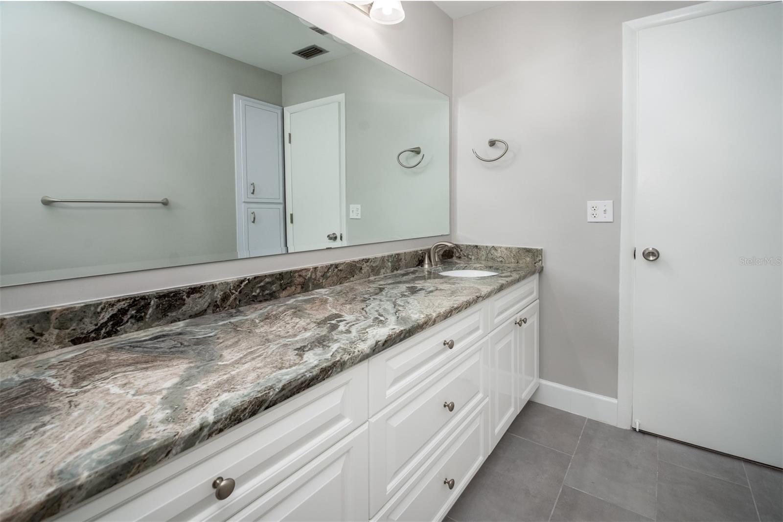 Ensuite bathroom with a 60” frameless glass-enclosed walk-in shower