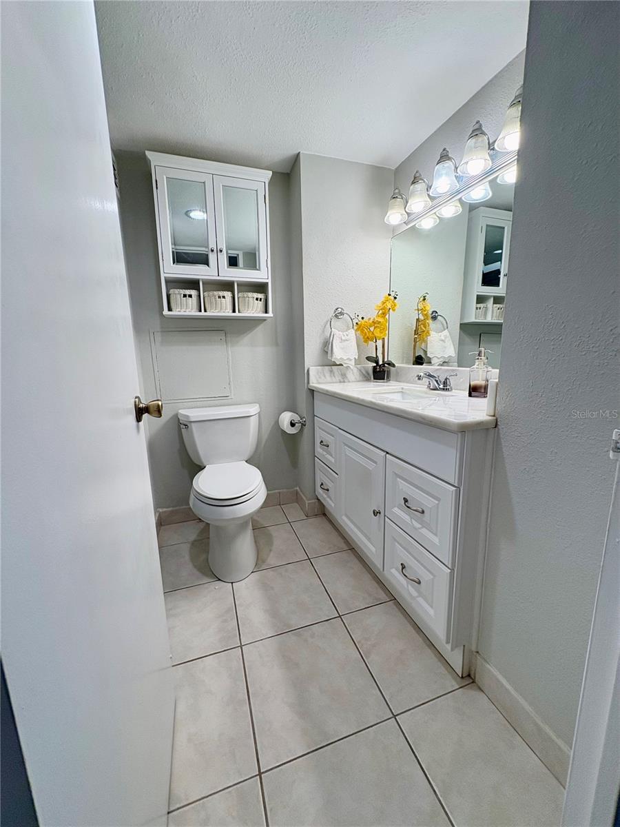 Bathroom with full sized vanity mirror