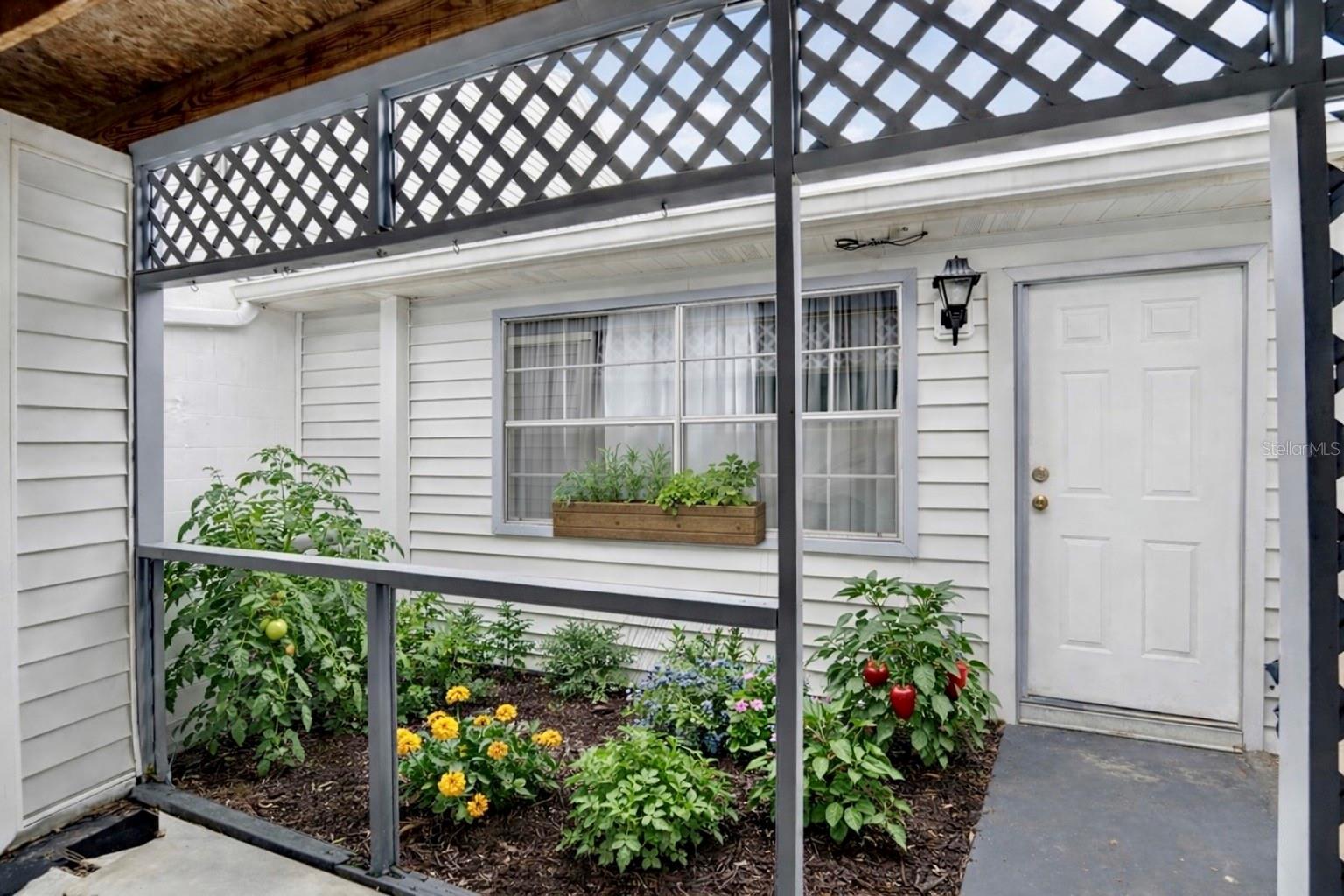 VIRTUAL STAGED FRONT DOOR/GARDEN AREA